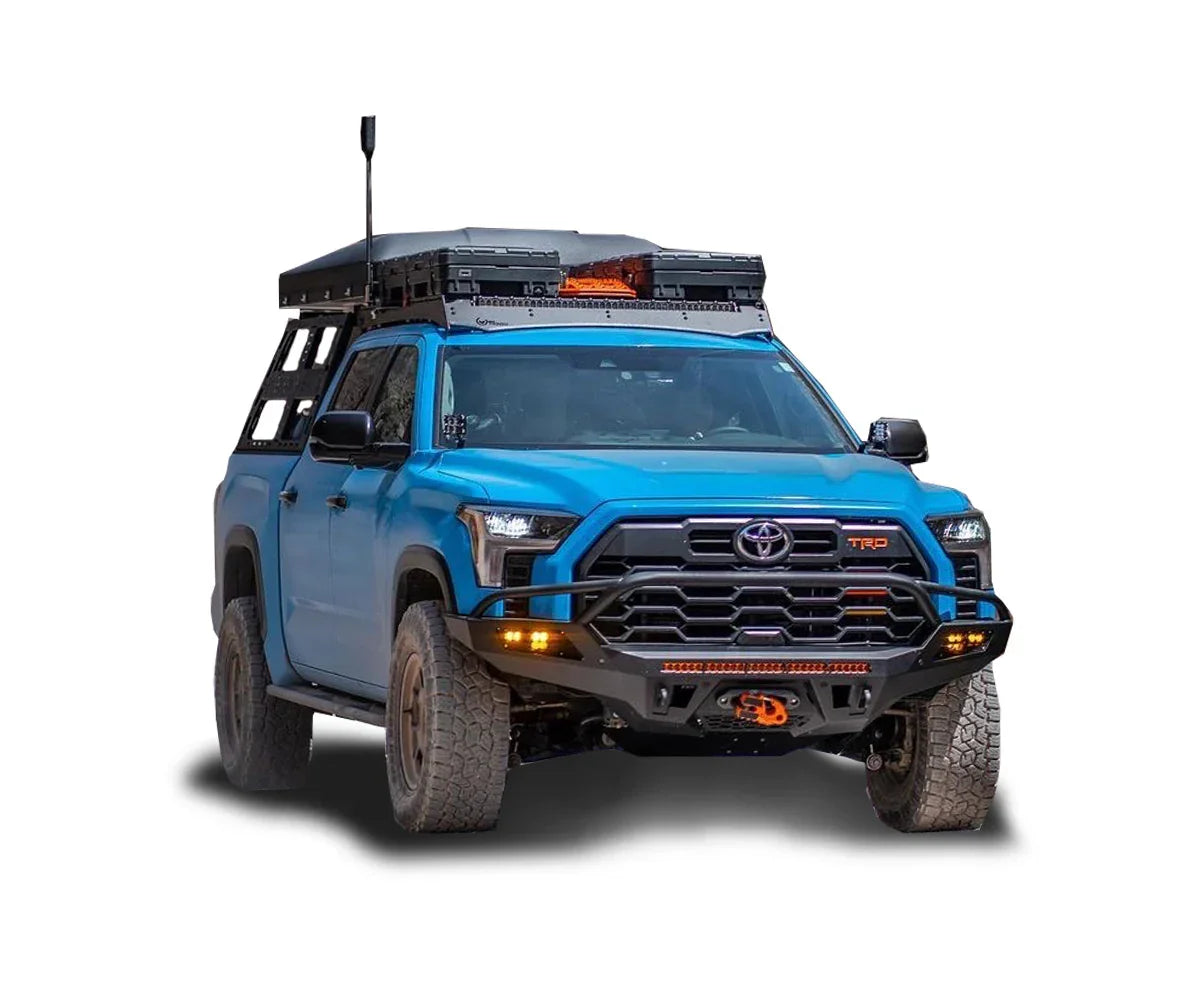 Blue Toyota Tundra TRD with overlanding rack, rooftop tent, off-road bumper, and accessories