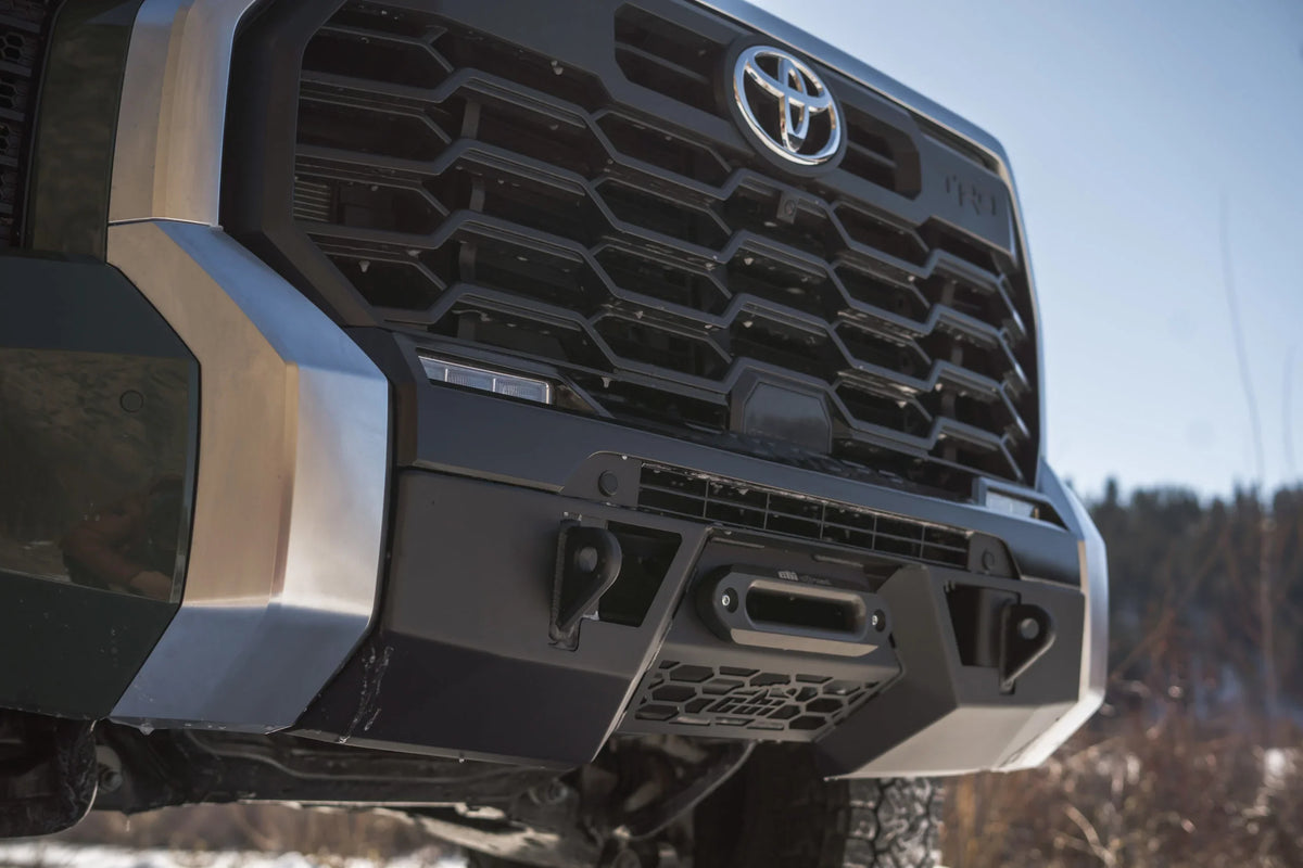 Close-up of Toyota Tundra TRD front grille with off-road bumper and winch mount
