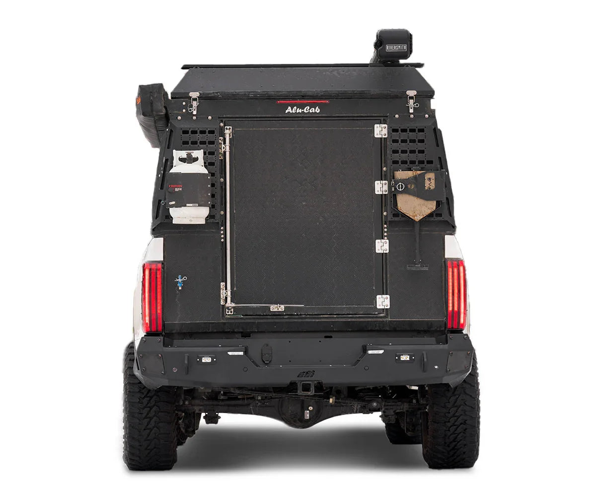 Toyota Tundra rear with overlanding Alu-Cab canopy and mounted camping gear accessories