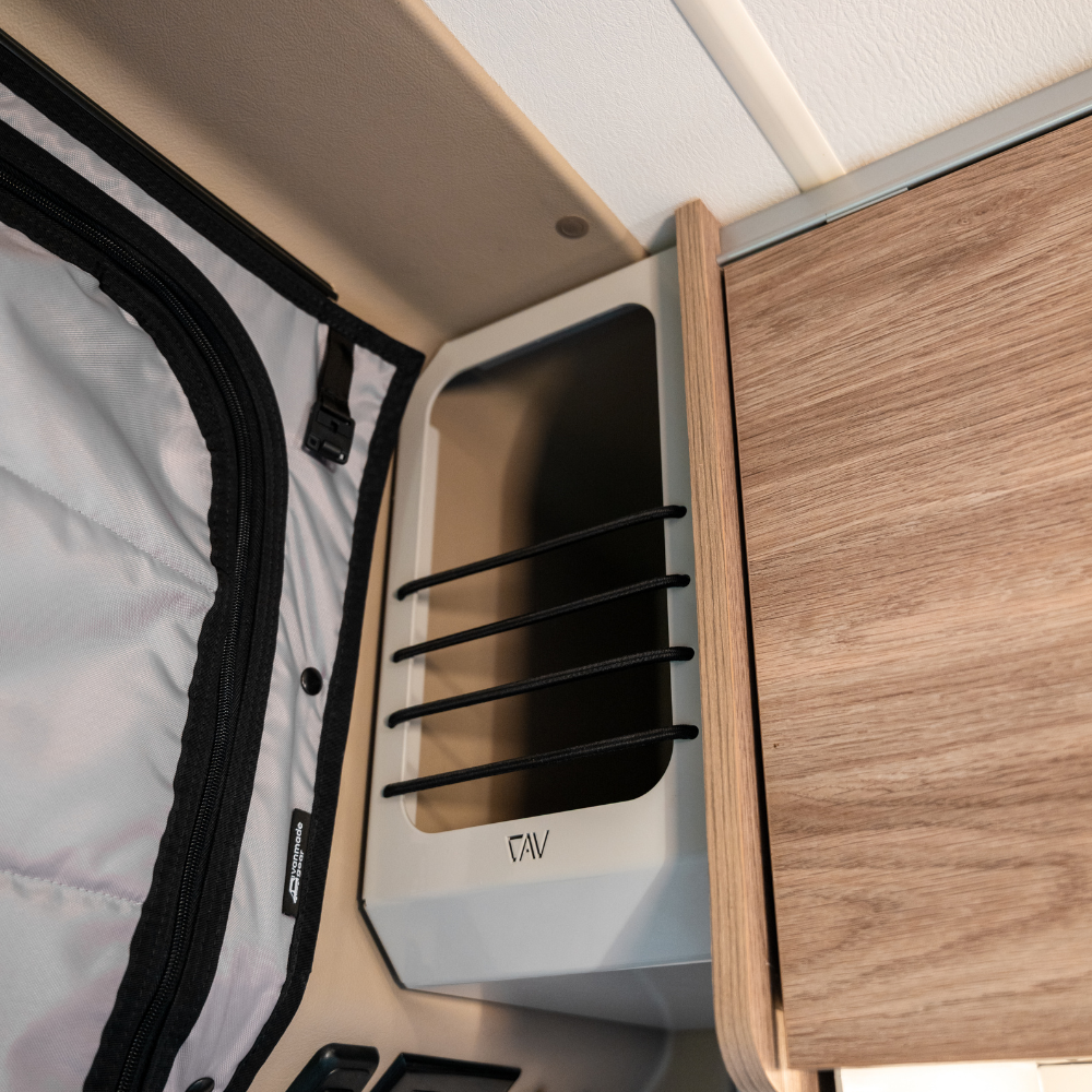 Overland vehicle interior storage organizer mounted near wood panel and fabric door