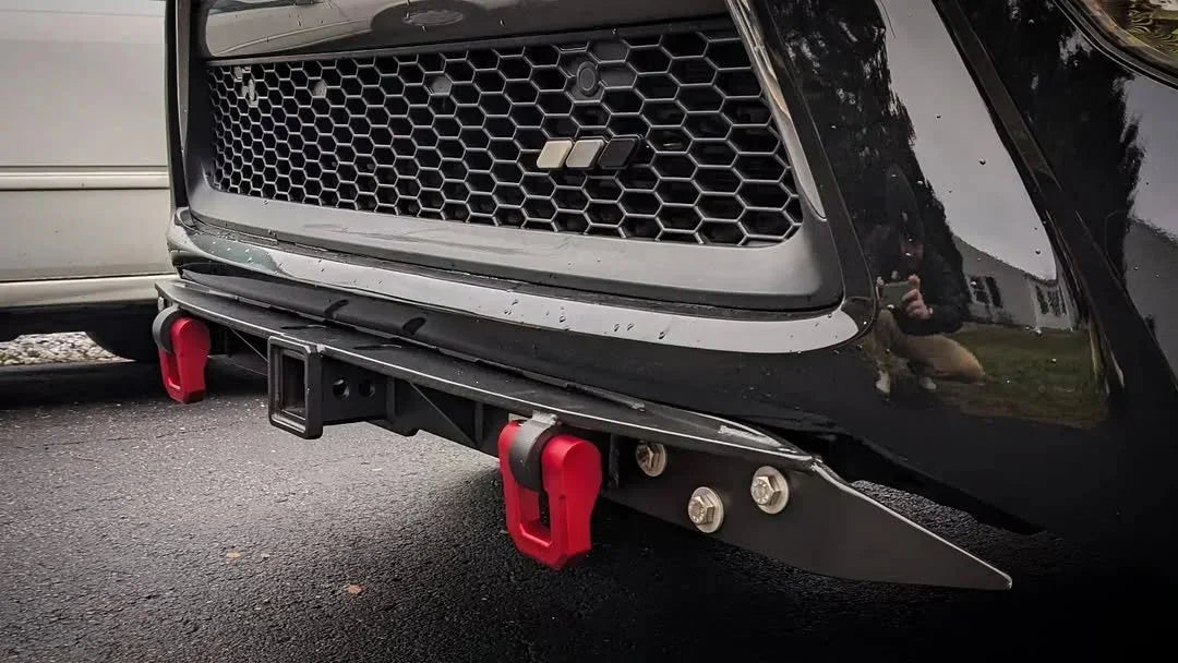 Off-road vehicle steel front bumper with red recovery hooks and hitch receiver