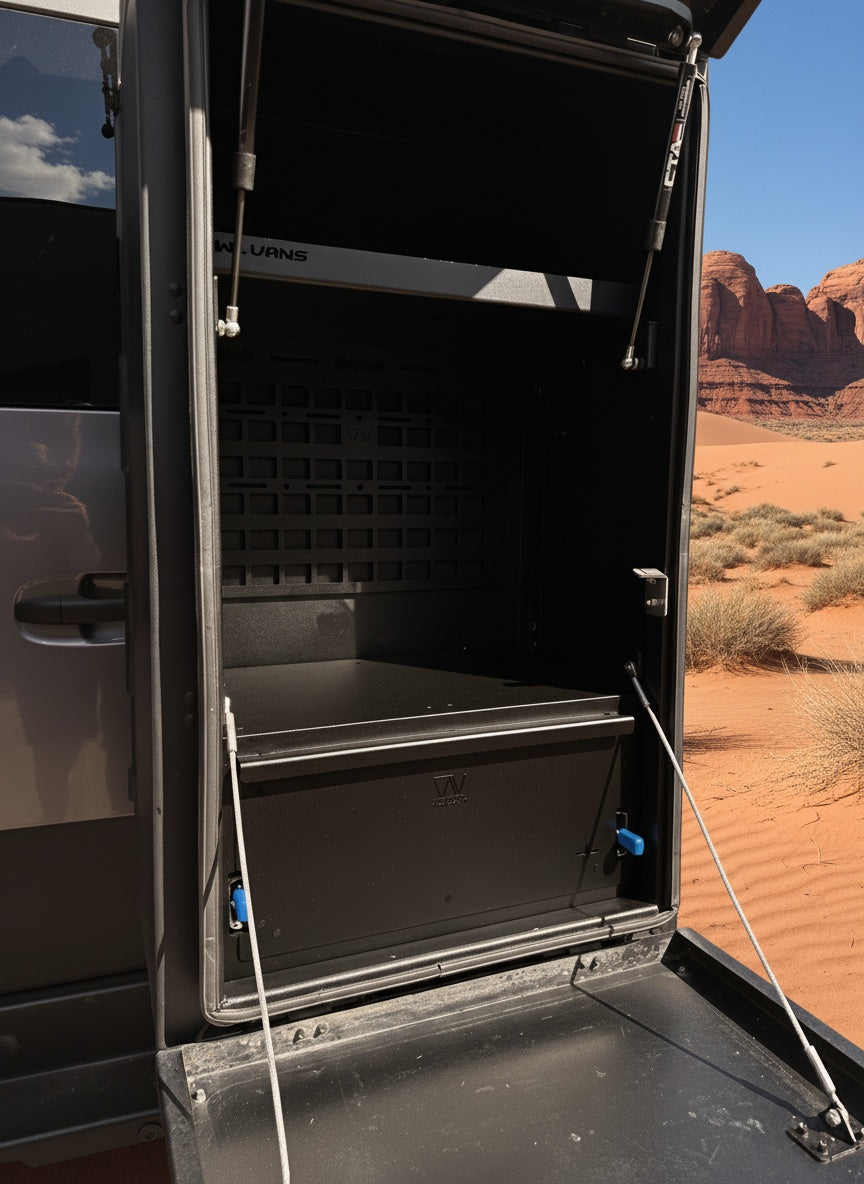 Open overland storage box mounted on vehicle door in desert landscape