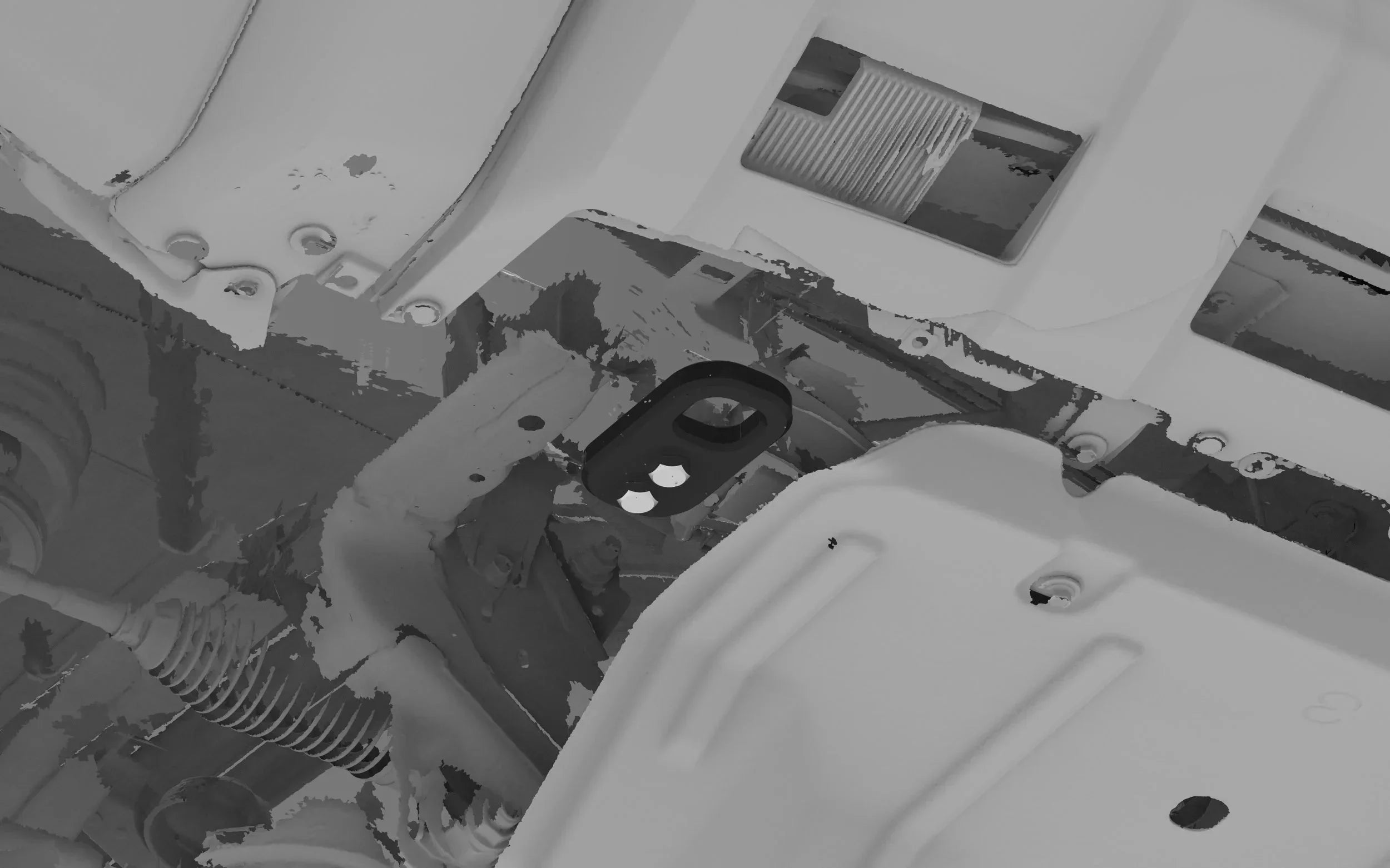 Aftermarket recovery point mounted under vehicle chassis near skid plate, suitable for overlanding.