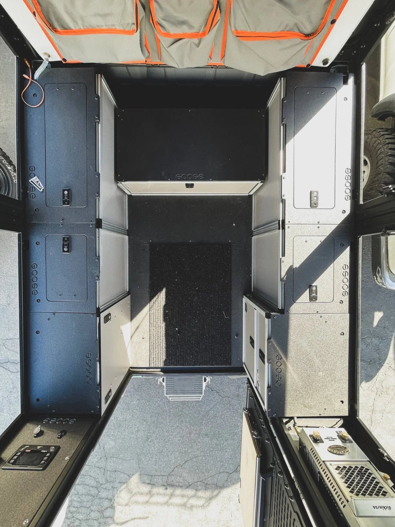 Custom storage system and bed platform inside Toyota Tundra overland canopy camper