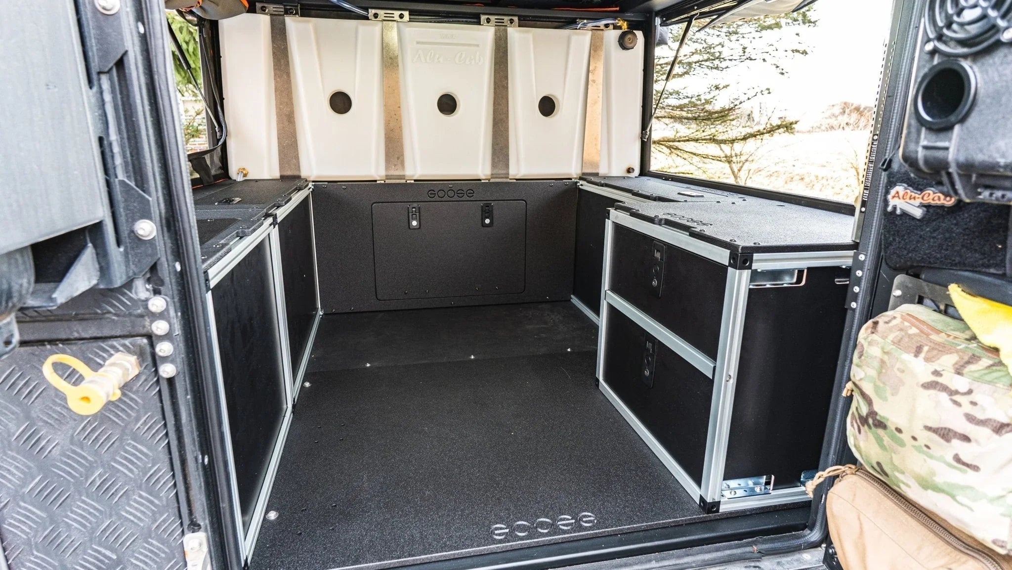 Alu-Cab canopy camper interior with rear double drawer storage system installed in a Chevy Colorado or GMC Canyon 2nd gen 6' bed, designed for overlanding and camping organization.