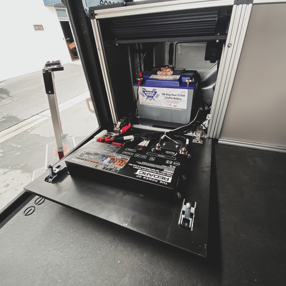 Goose Gear rear power management module in an Alu-Cab canopy on a 6-foot Toyota Tacoma bed with battery and wiring
