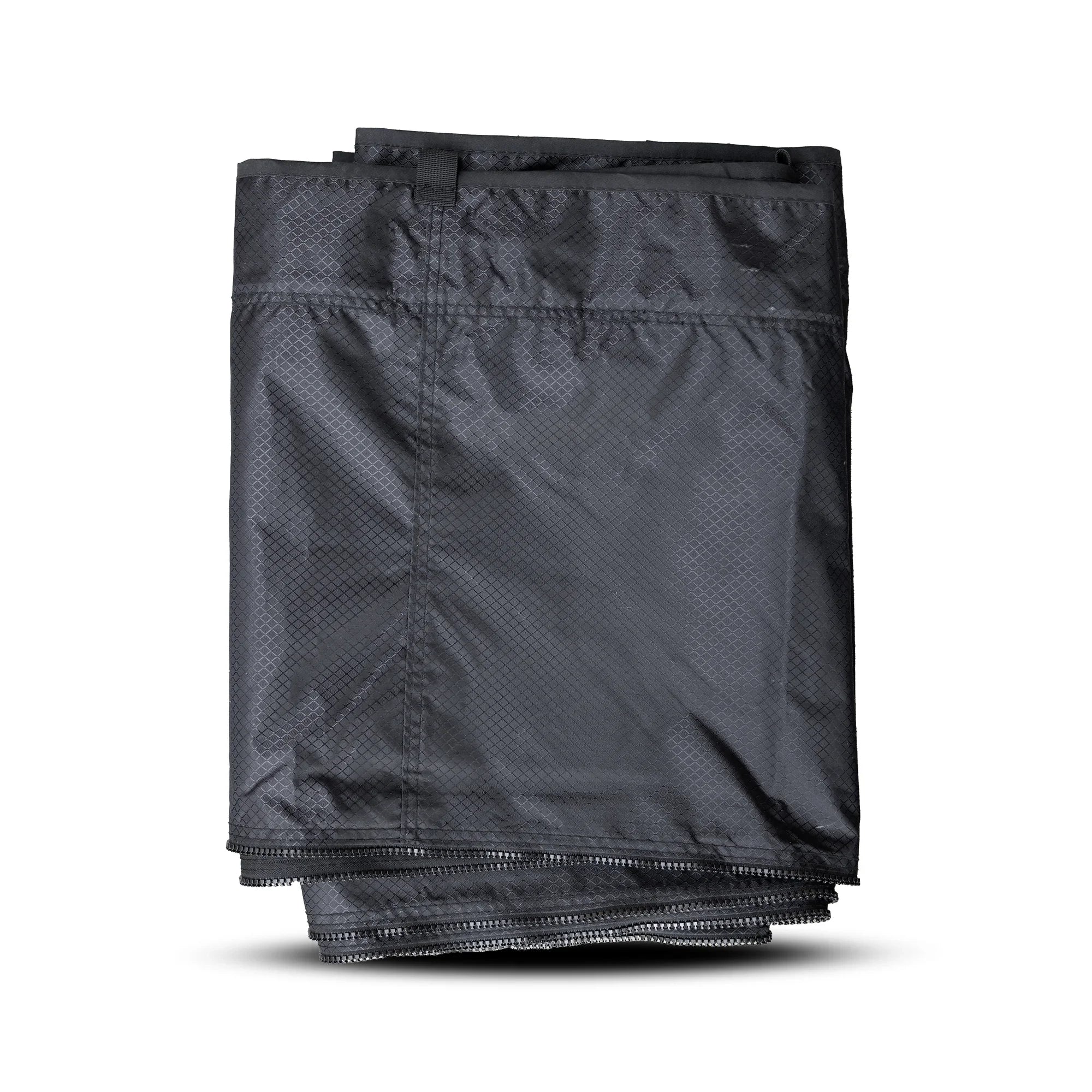 Folded black annex extension tent wall for vehicle camping and overlanding gear