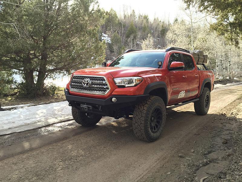 Toyota Tacoma 2016-2021 with off-road front bumper on a dirt trail, overland setup
