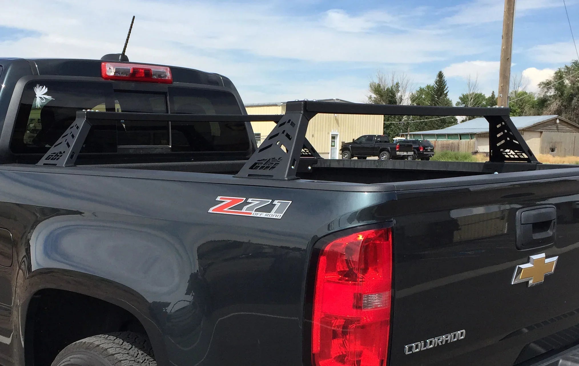 Chevrolet Colorado pickup truck with black steel bed bars, ideal for overlanding gear