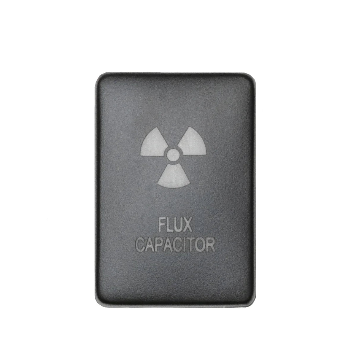 Black automotive switch cover labeled 'Flux Capacitor' with a radiation symbol, accessory part.