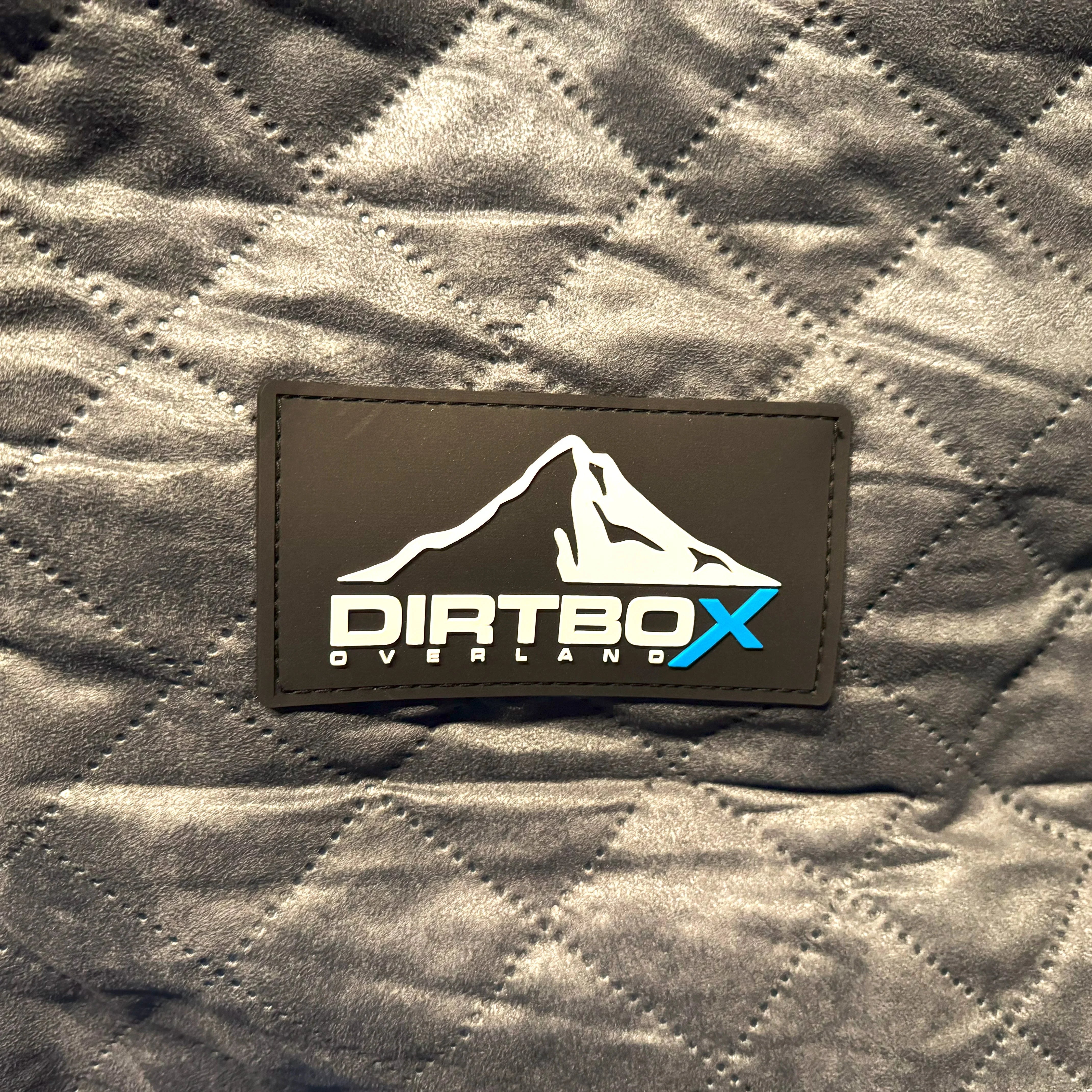 Quilted gray insulation blanket with Dirtbox Overland patch for vehicle winterizing