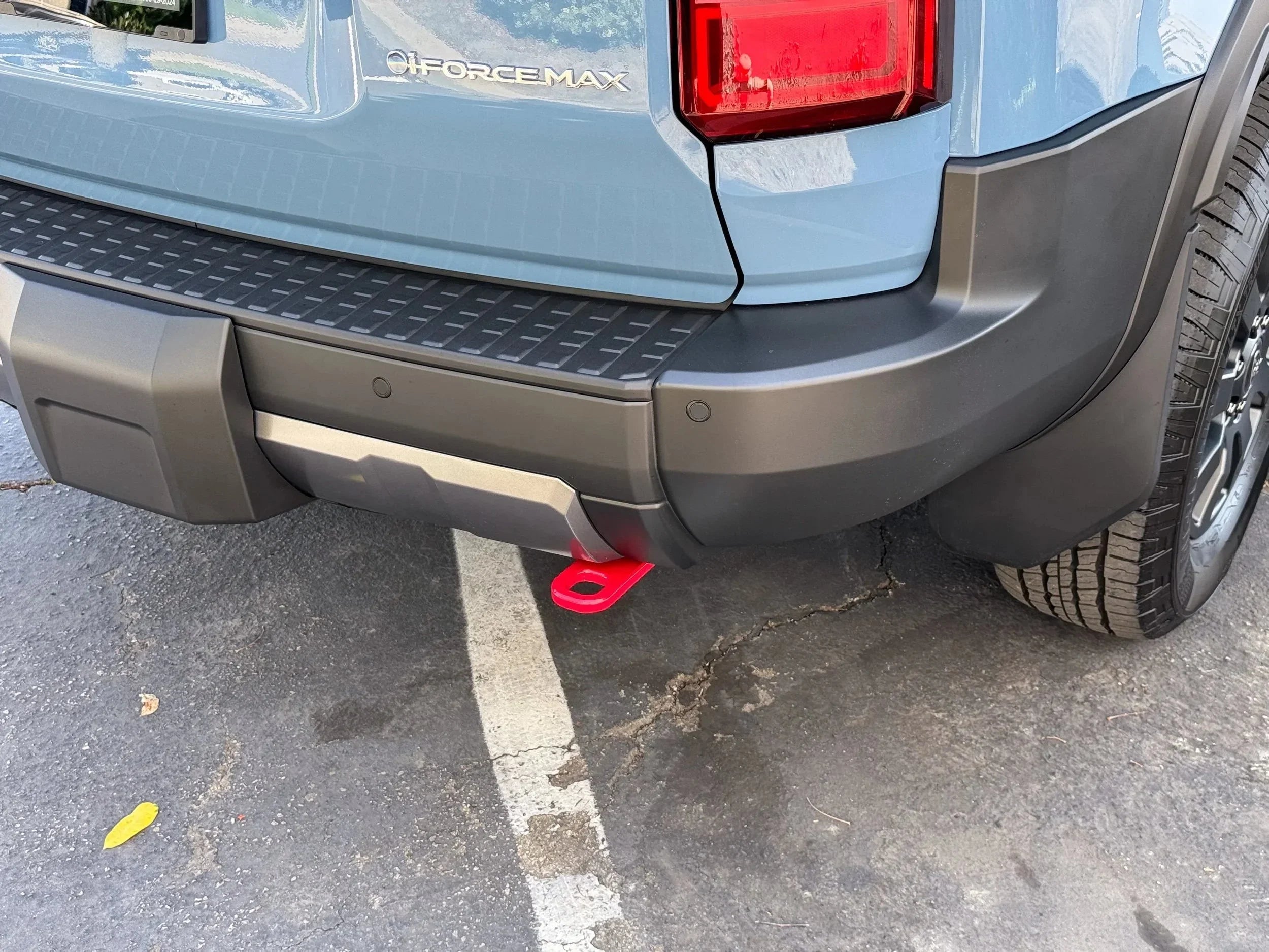 Toyota truck rear bumper with red recovery tow hook for overlanding accessories