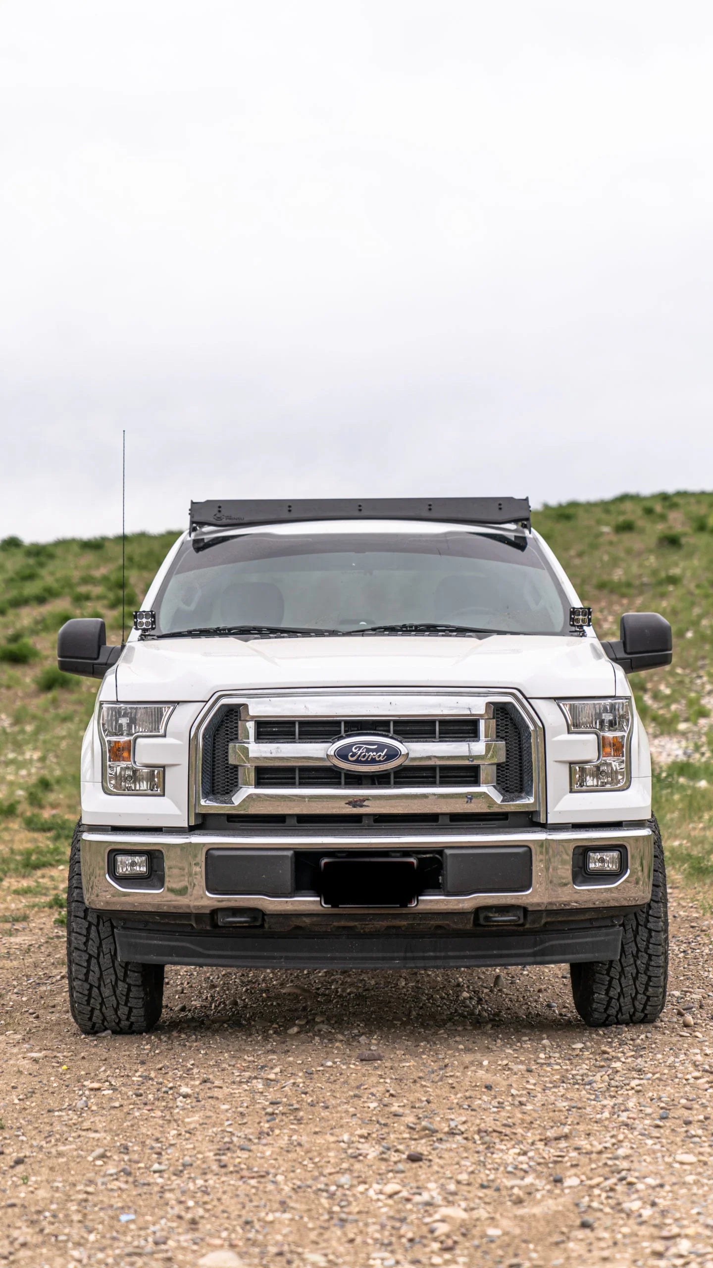 Ford F-150 truck with roof rack on off-road terrain