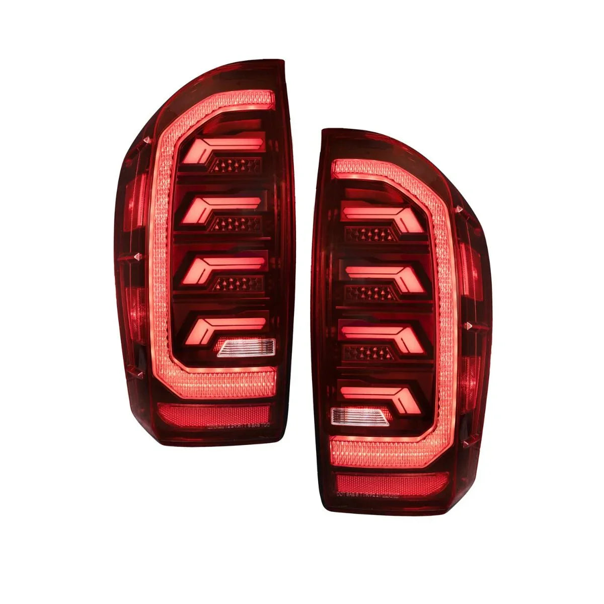 Pair of red LED taillights for 2016 Toyota Tacoma, illuminated, on white background.