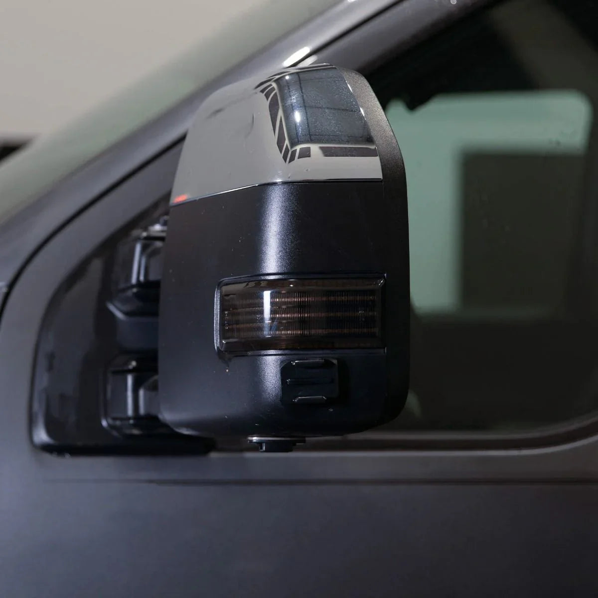 2017 Ford F250 tow mirror with smoked lens and integrated turn signal in studio lighting
