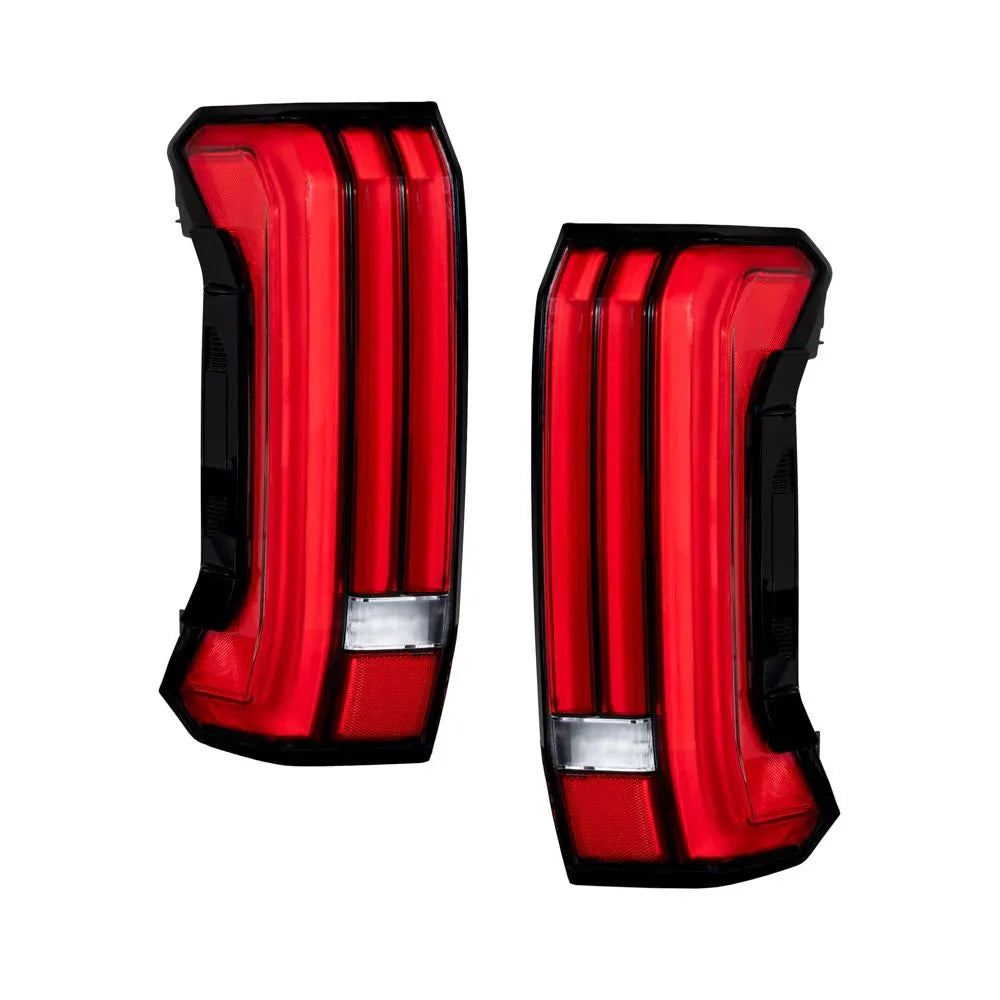 Pair of red 2024 Toyota Tundra LED taillights with black trim on white background