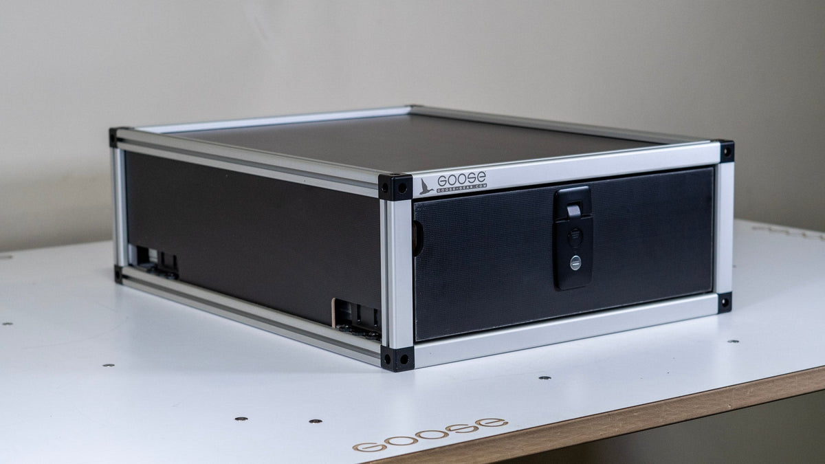 Goose Gear single drawer module for a Ford Bronco, black front panel and latch, shown on a workbench