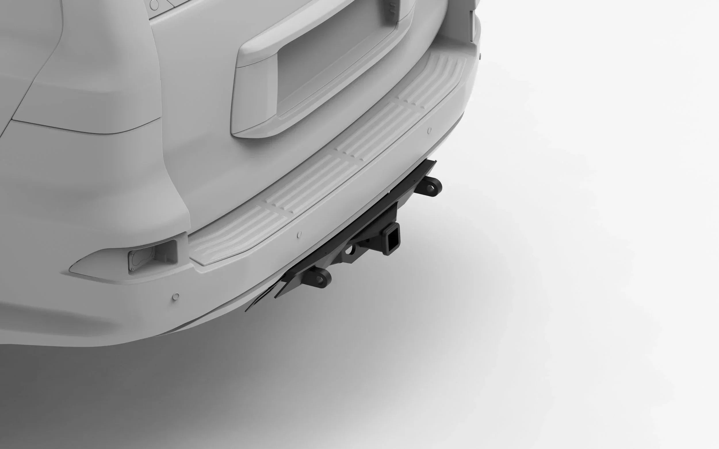 Rear view of vehicle with aftermarket off-road hitch receiver and recovery points installed