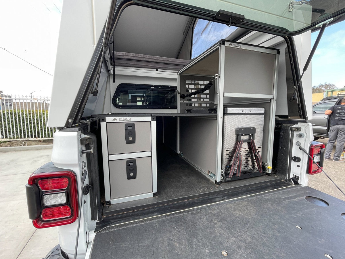 Goose Gear camper system driver side rear double drawer module in a truck bed under a topper, with storage above