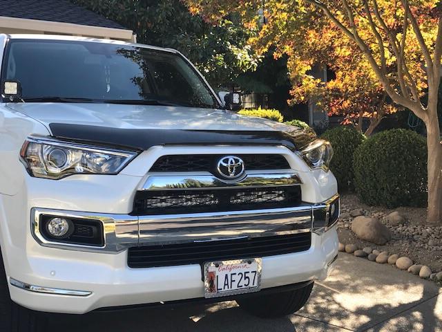 White Toyota 4Runner SUV parked outdoors with chrome grill, ideal for overlanding upgrades.
