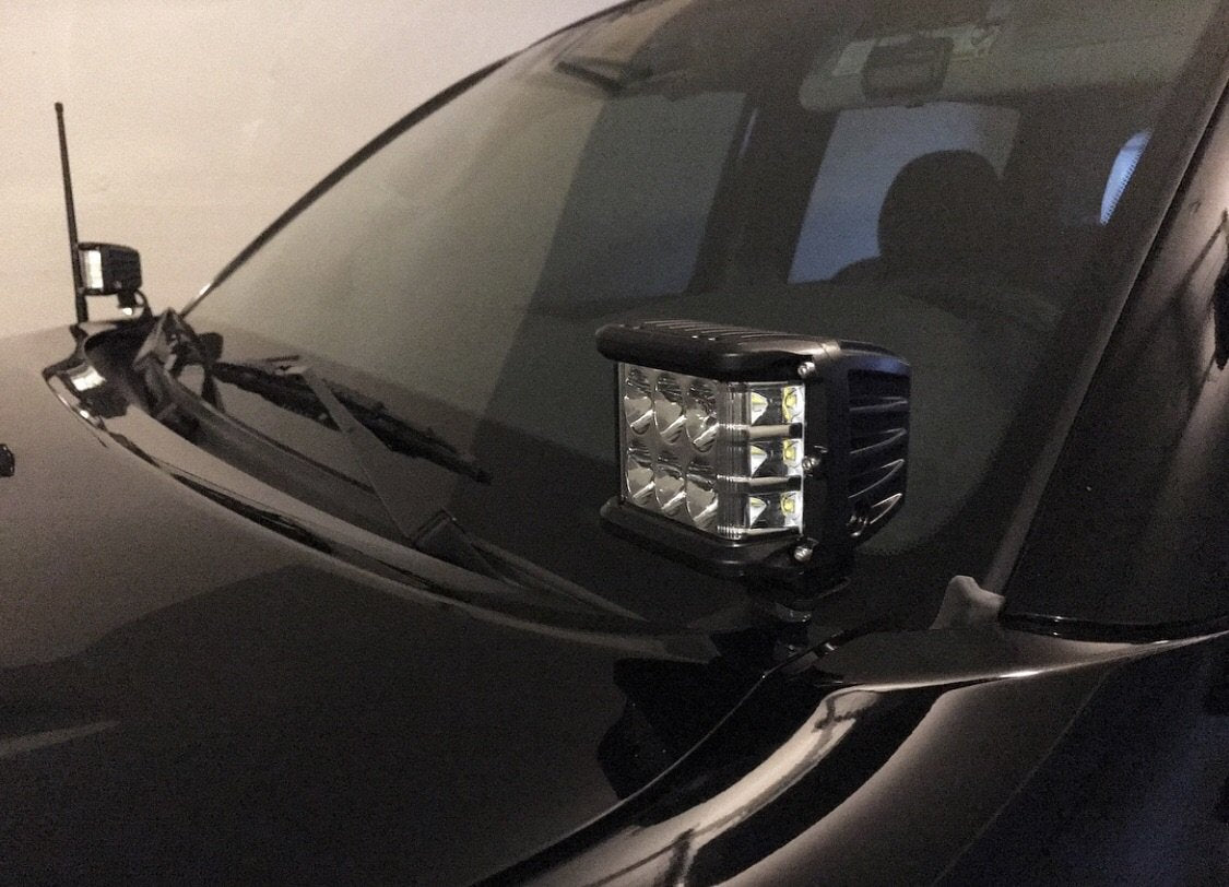 LED off-road pod light mounted on hood of black vehicle, ideal for overlanding