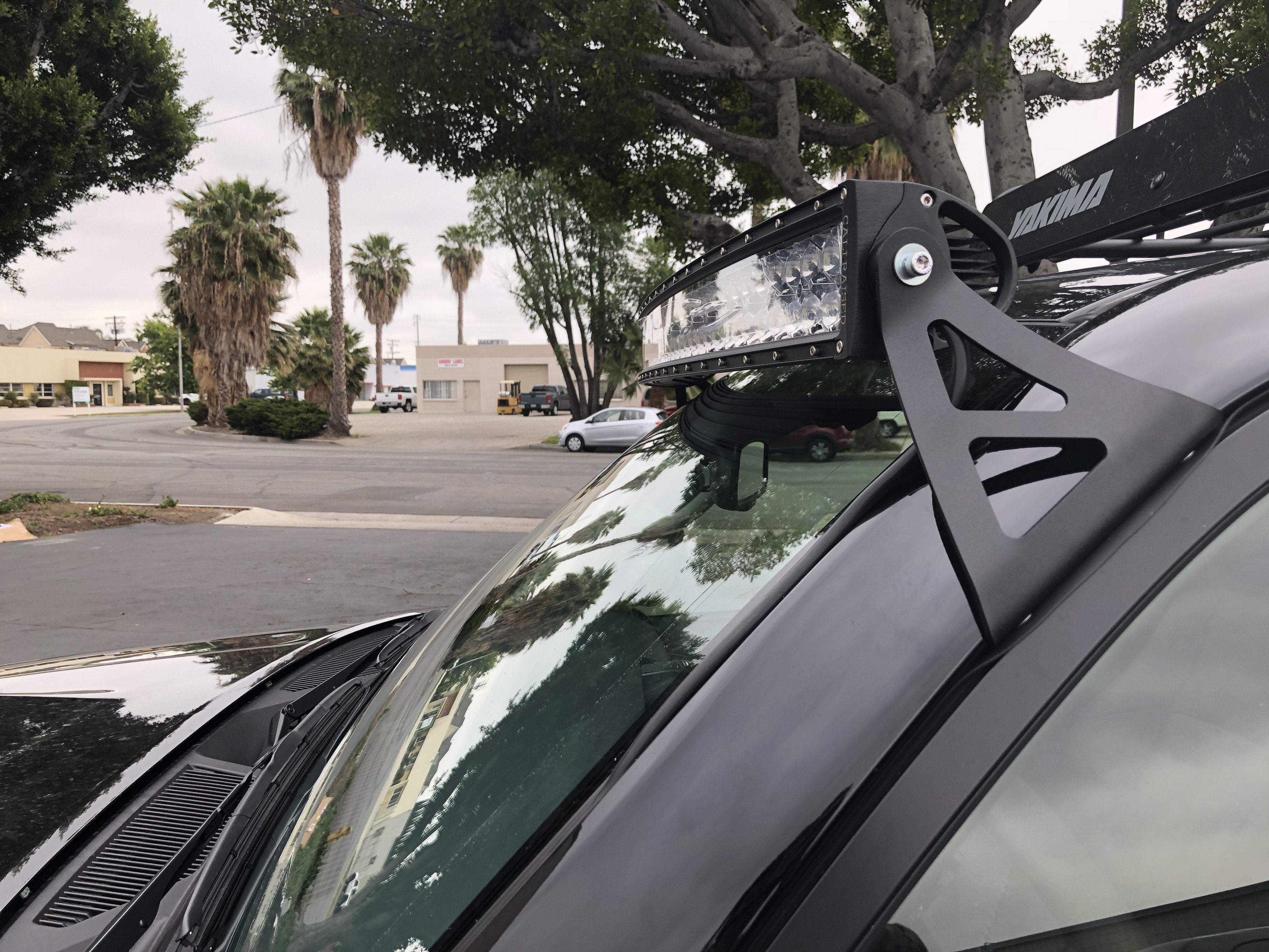 Close-up of Yakima roof rack with LED light bar on vehicle for overlanding and camping