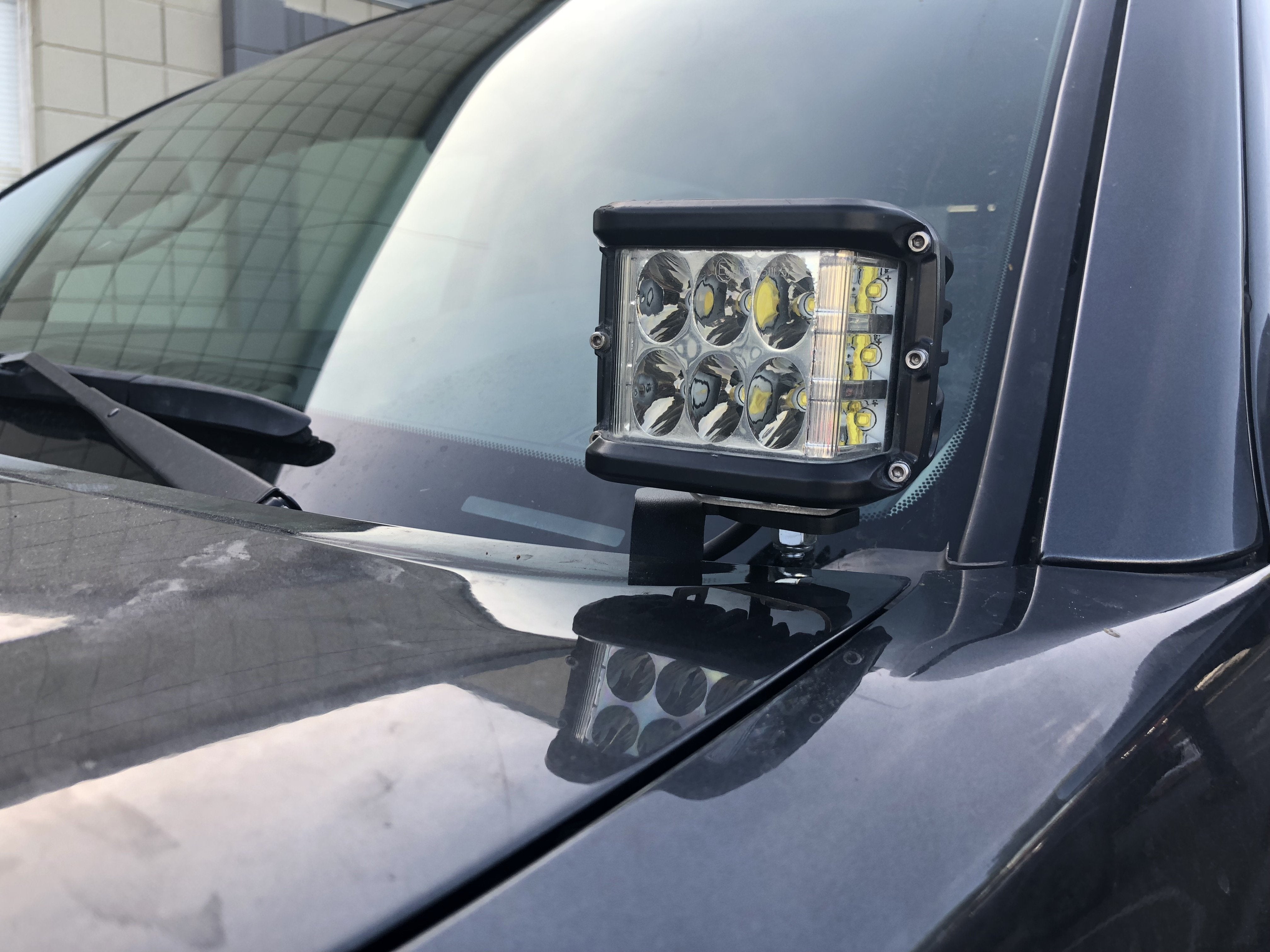 LED off-road light mounted on vehicle hood for overlanding and expedition use