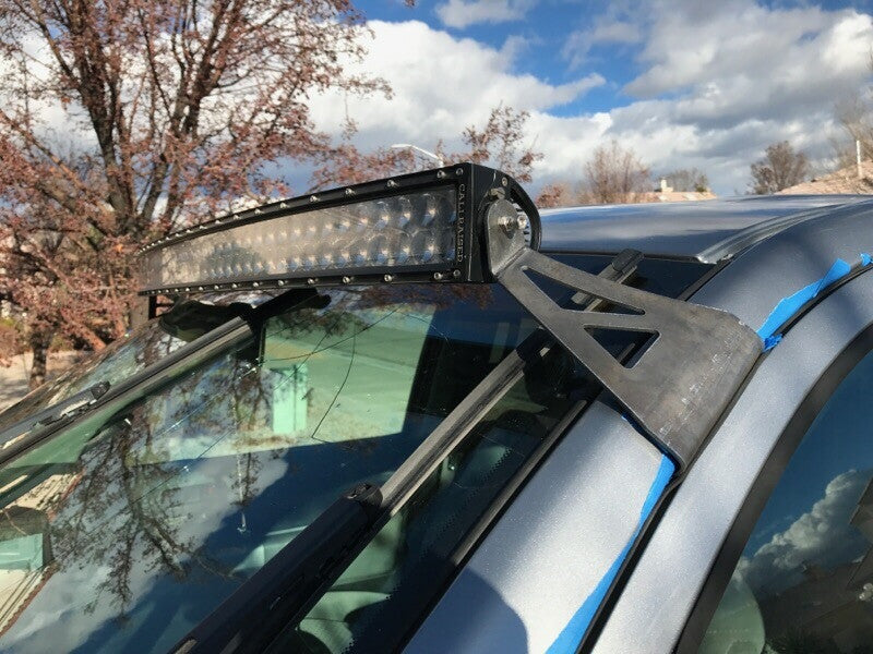 LED light bar mounted on vehicle roof with custom bracket for overlanding or off-road use