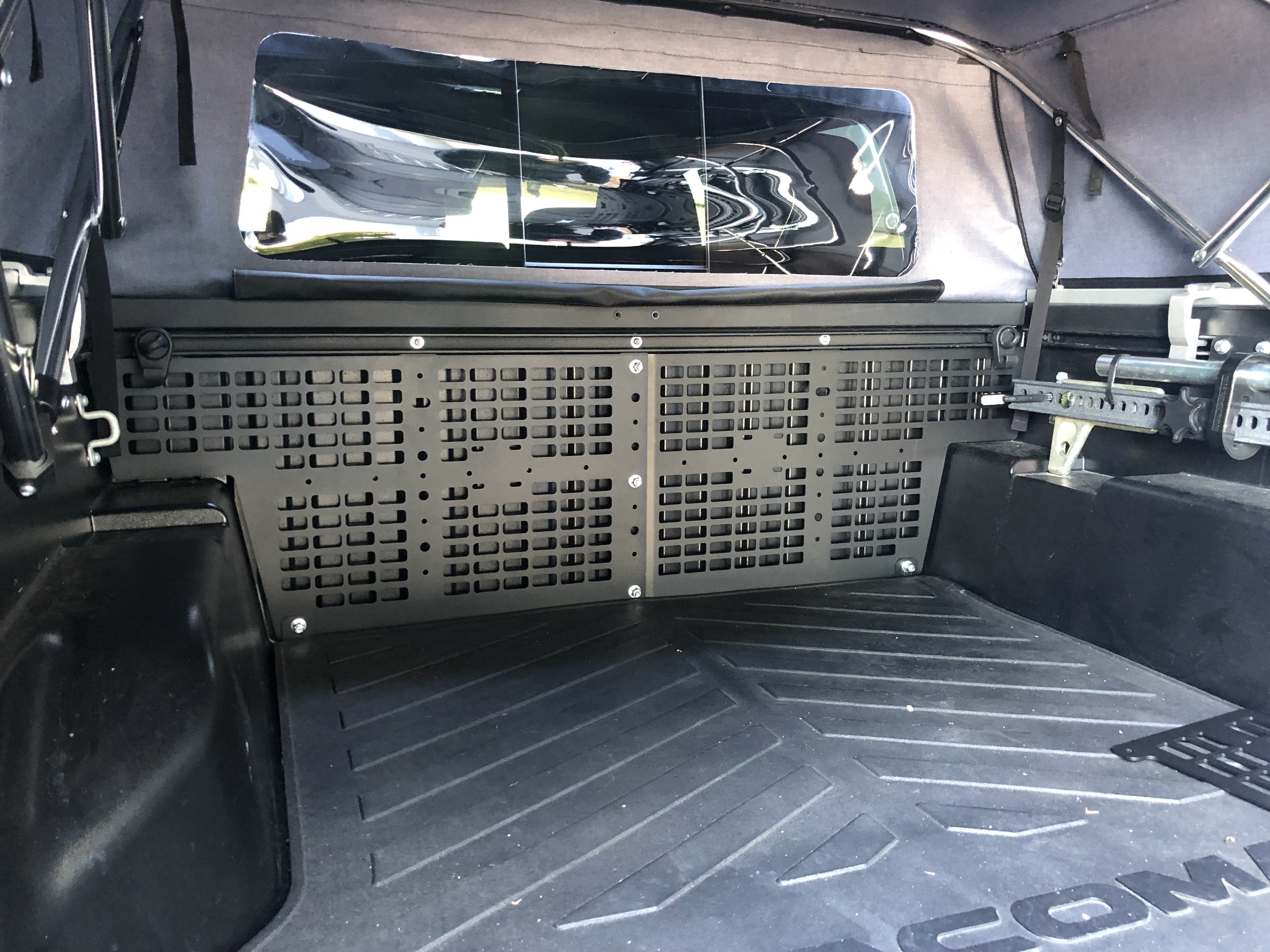 Toyota Tacoma truck bed with modular storage panel and overlanding gear rack