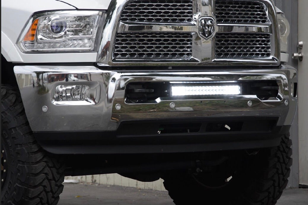 Chrome front bumper of a pickup truck with off-road LED light bar installed