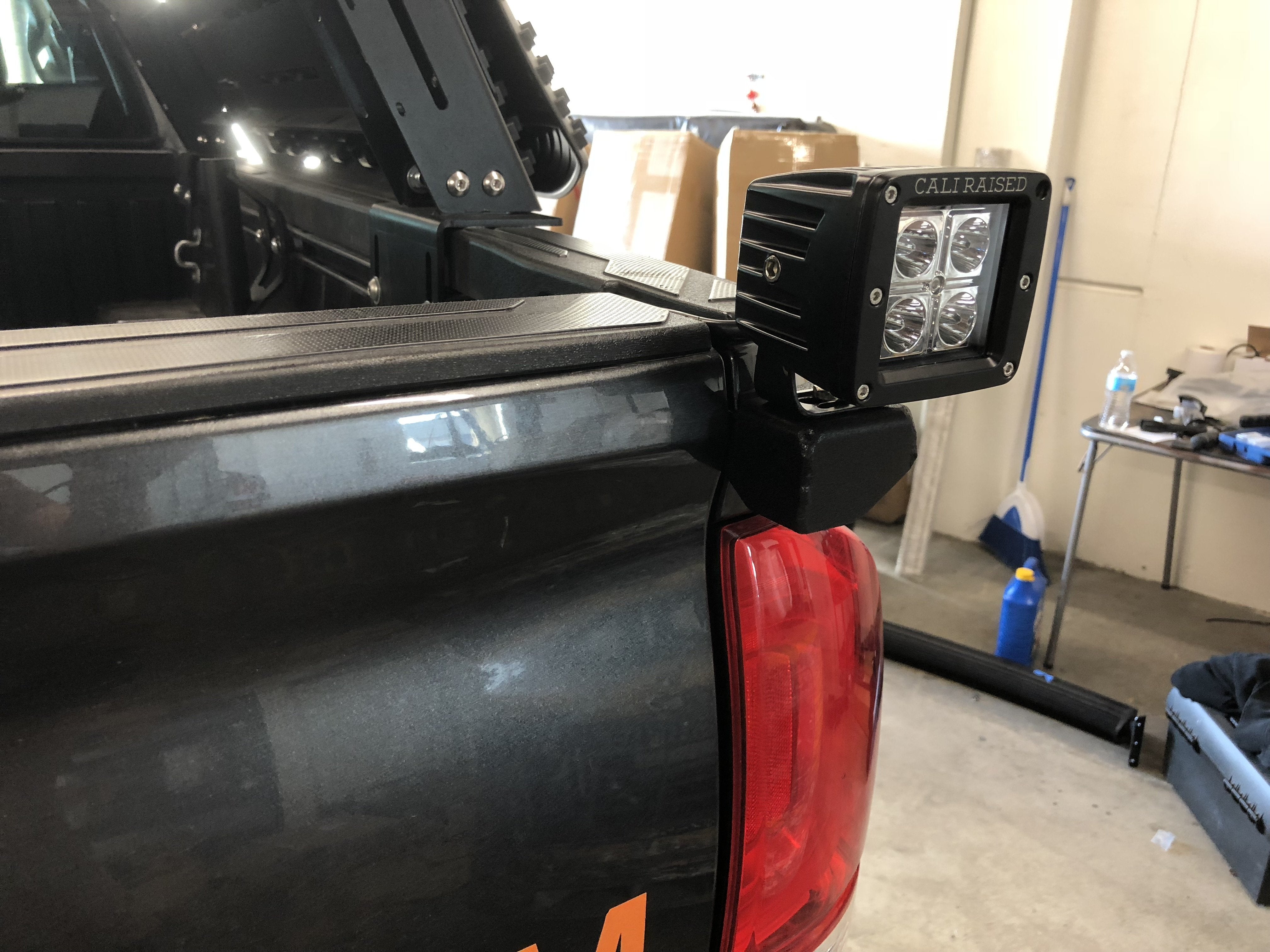 Cali Raised LED bed light mounted on Toyota Tacoma truck bed rack for overlanding