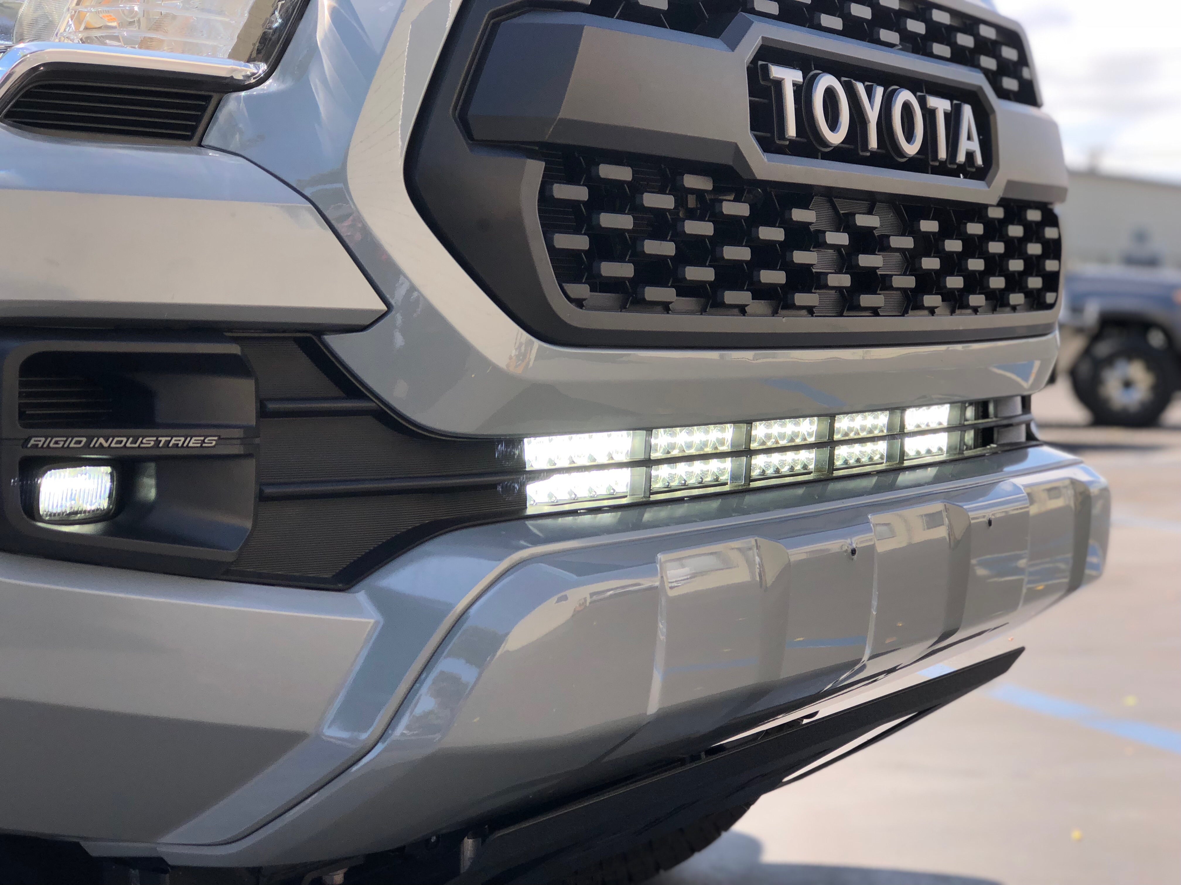 Toyota truck front grille with LED light bar and Rigid Industries fog lights for off-road