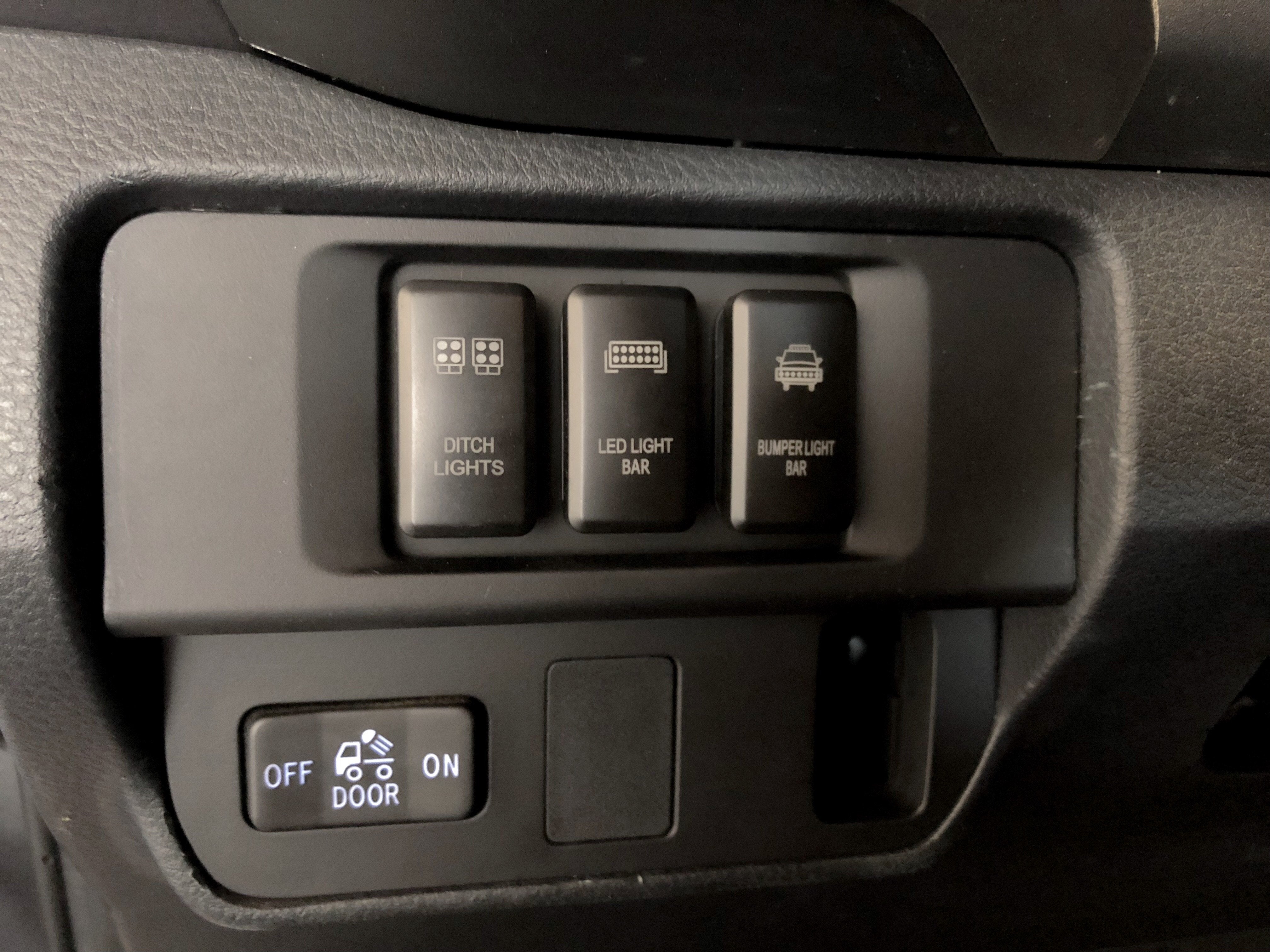 Toyota vehicle dashboard with ditch lights, LED light bar, and bumper light bar switches