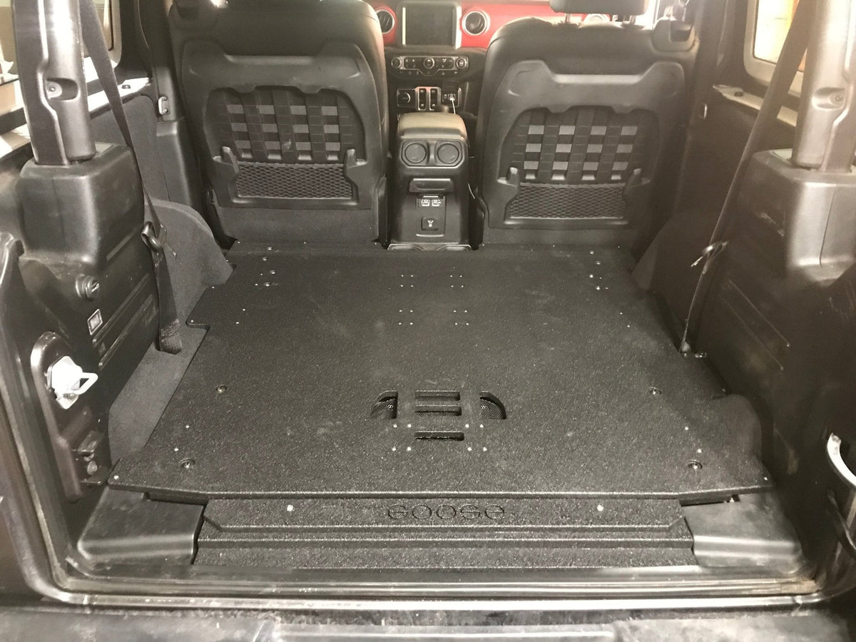 Goose Gear rear plate system installed in a Jeep Wrangler JL 2-door, flat black platform behind the rear seats
