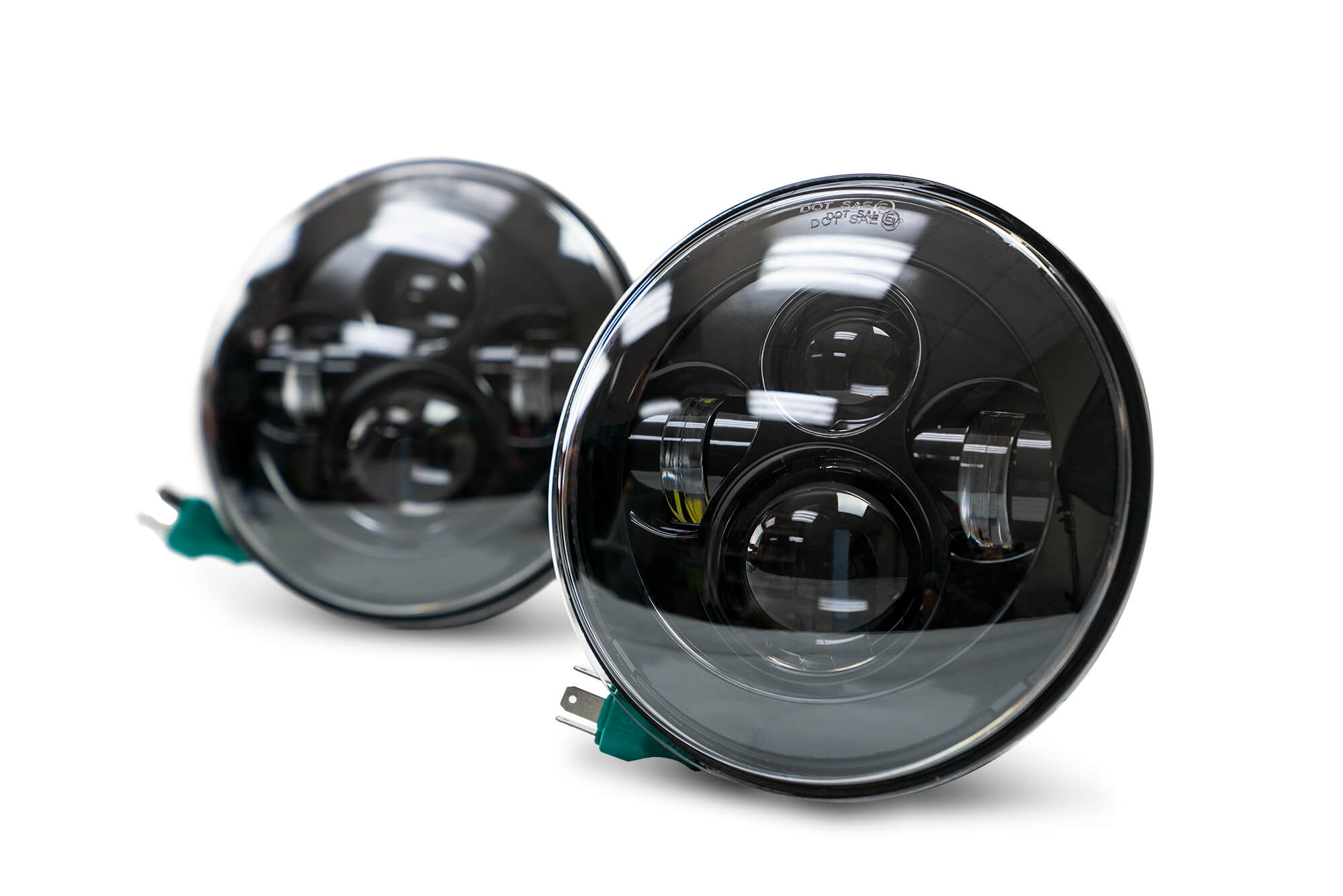 Pair of Jeep Wrangler JK round LED headlights on white background, close-up view