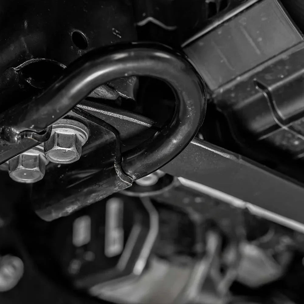 Close-up of heavy-duty off-road recovery hook and bolts on vehicle undercarriage