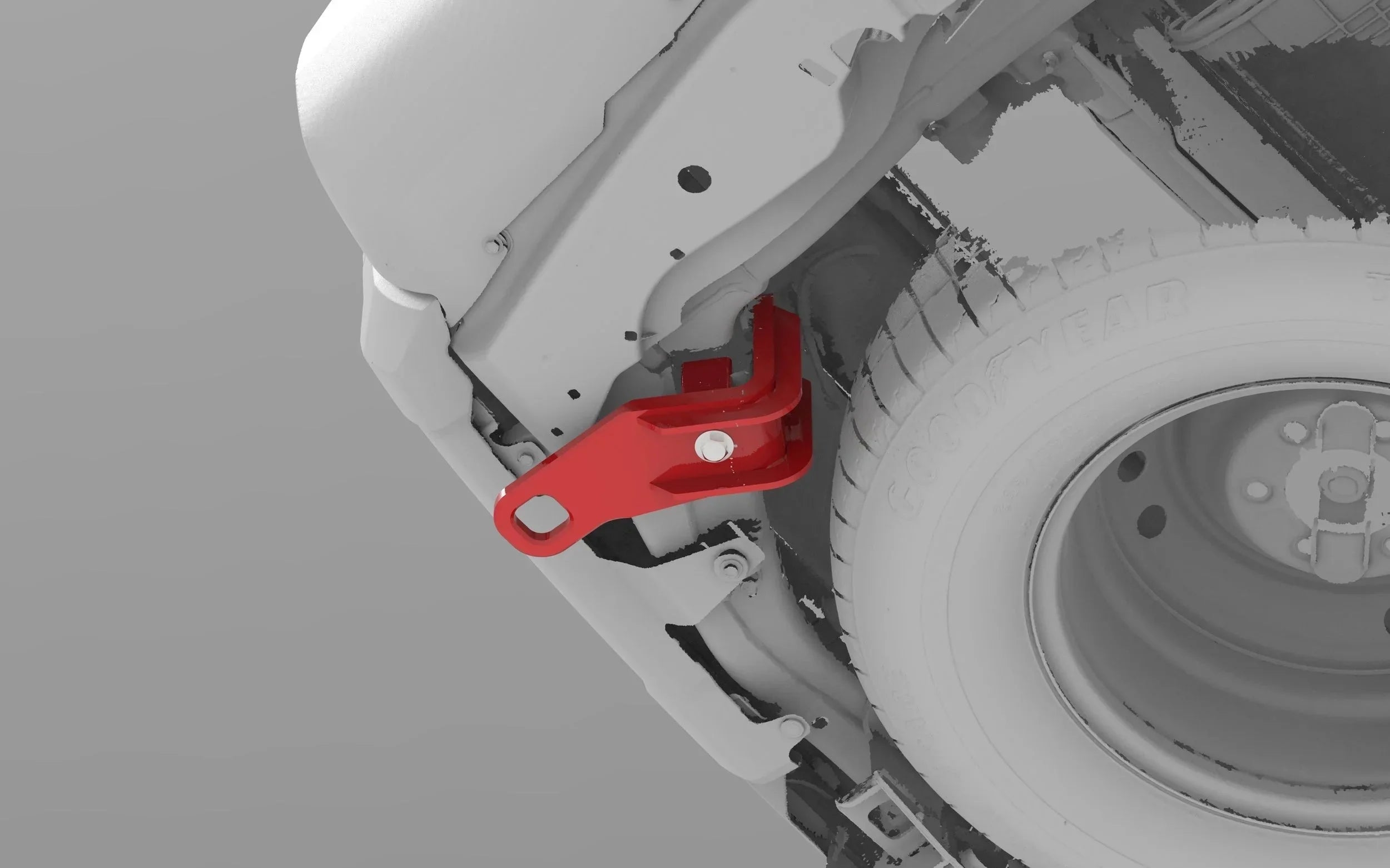 Red rear recovery point installed on off-road vehicle frame near spare tire