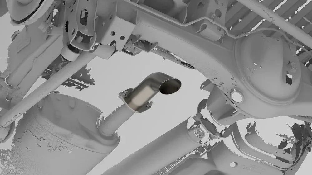 Aftermarket exhaust tip installed on Toyota Tacoma undercarriage for off-road vehicles