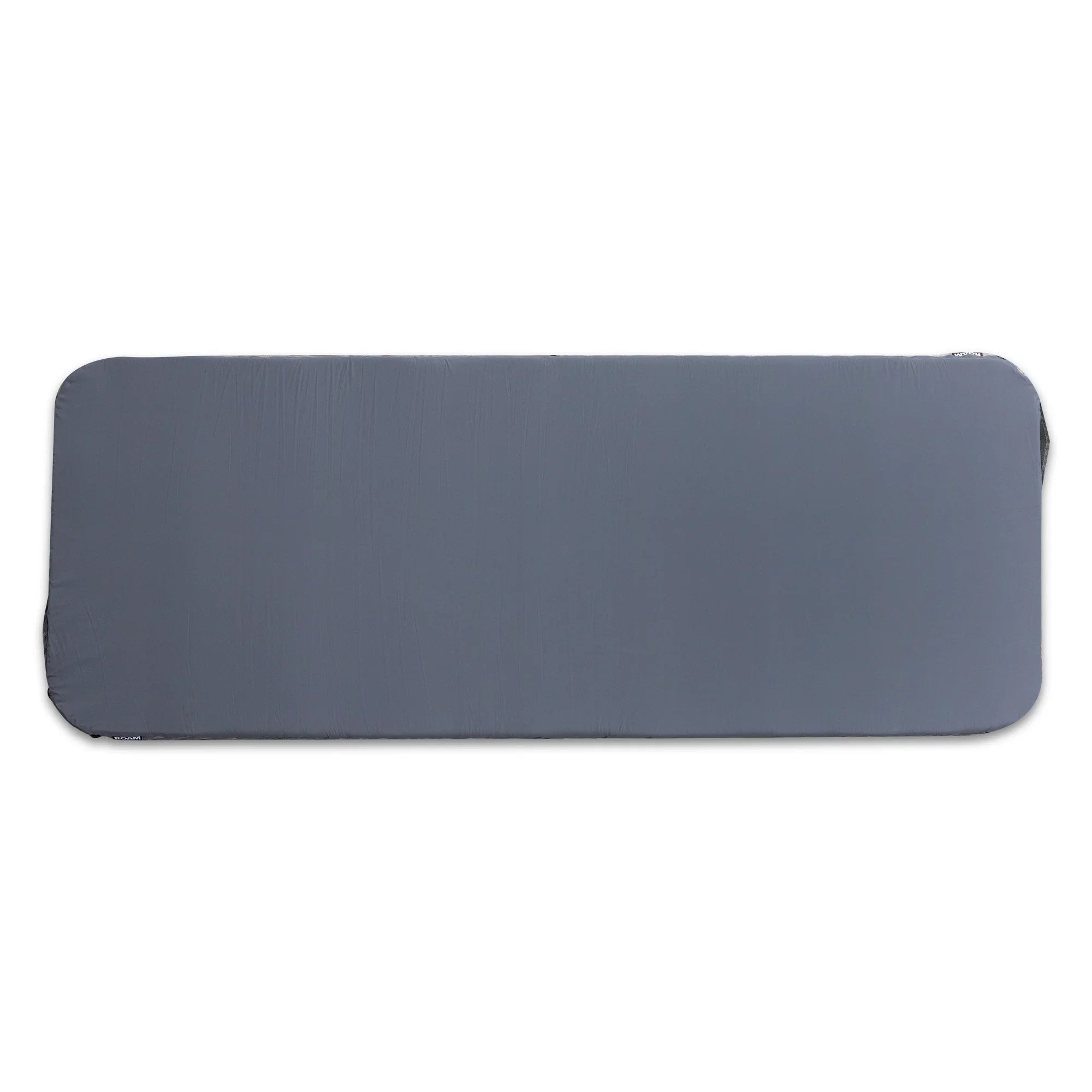 Gray rectangular camping sleeping pad with rounded corners, ideal for overlanding gear