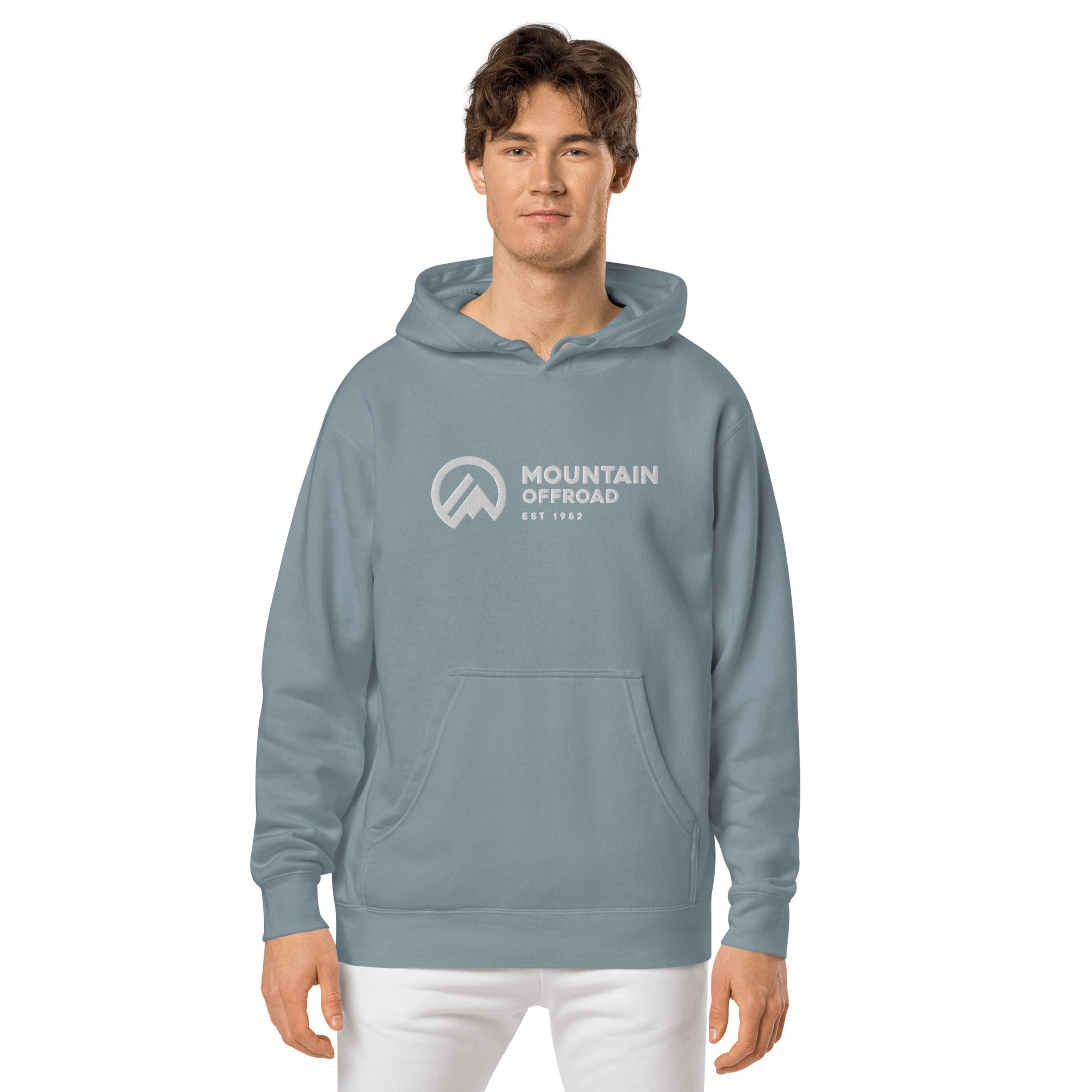 Man wearing vintage pigment dyed blue hoodie with Mountain Offroad logo and kangaroo pocket