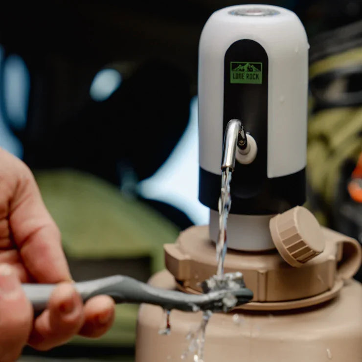 Portable camping water dispenser in use for overlanding, filling toothbrush with water