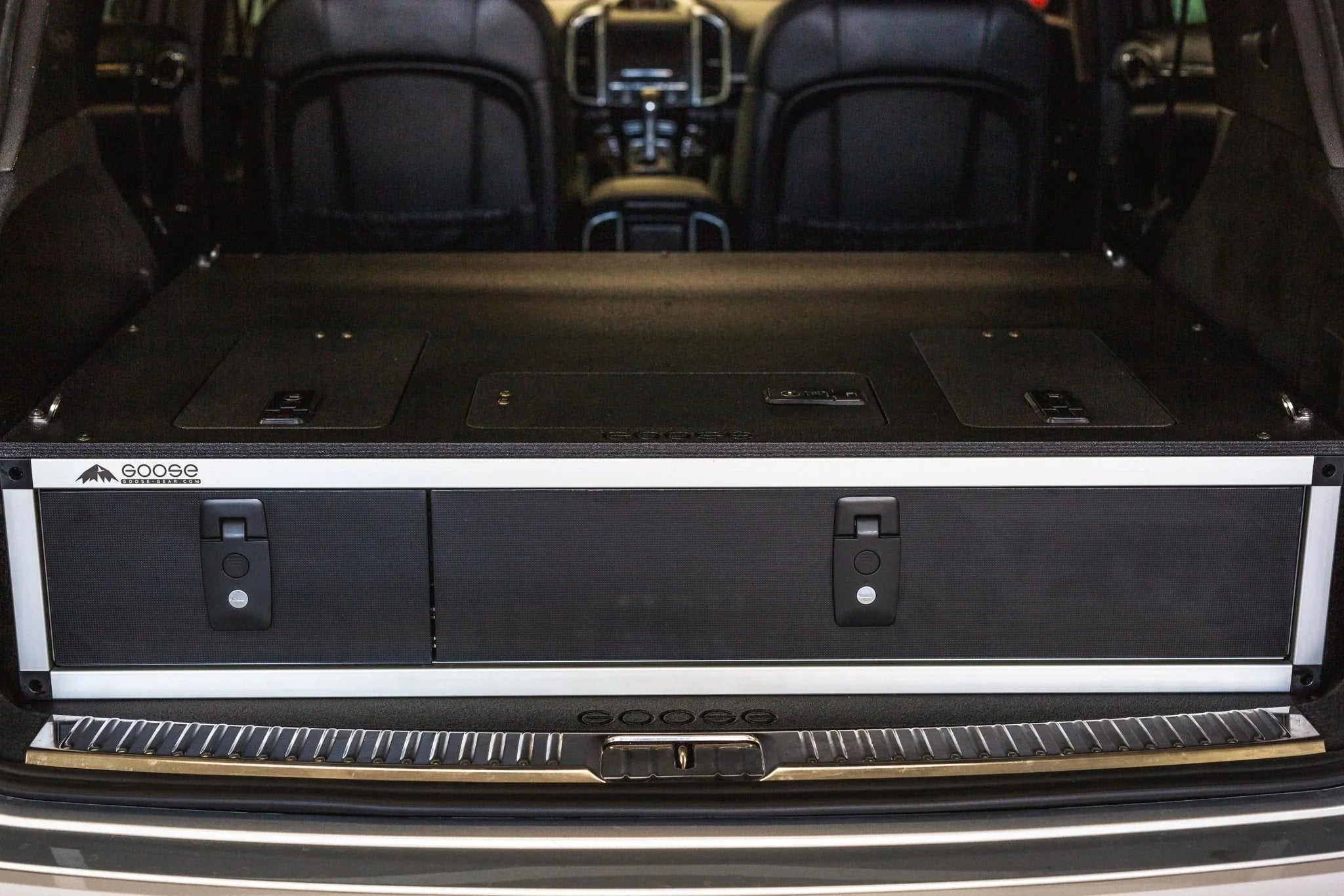 Side-by-side drawer storage module with fitted top plate in SUV cargo area, ideal for overlanding.