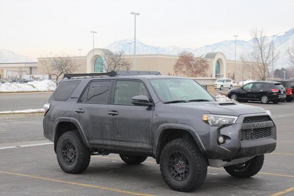 Toyota 4Runner with roof rack and off-road tires parked outdoors, ideal for overlanding