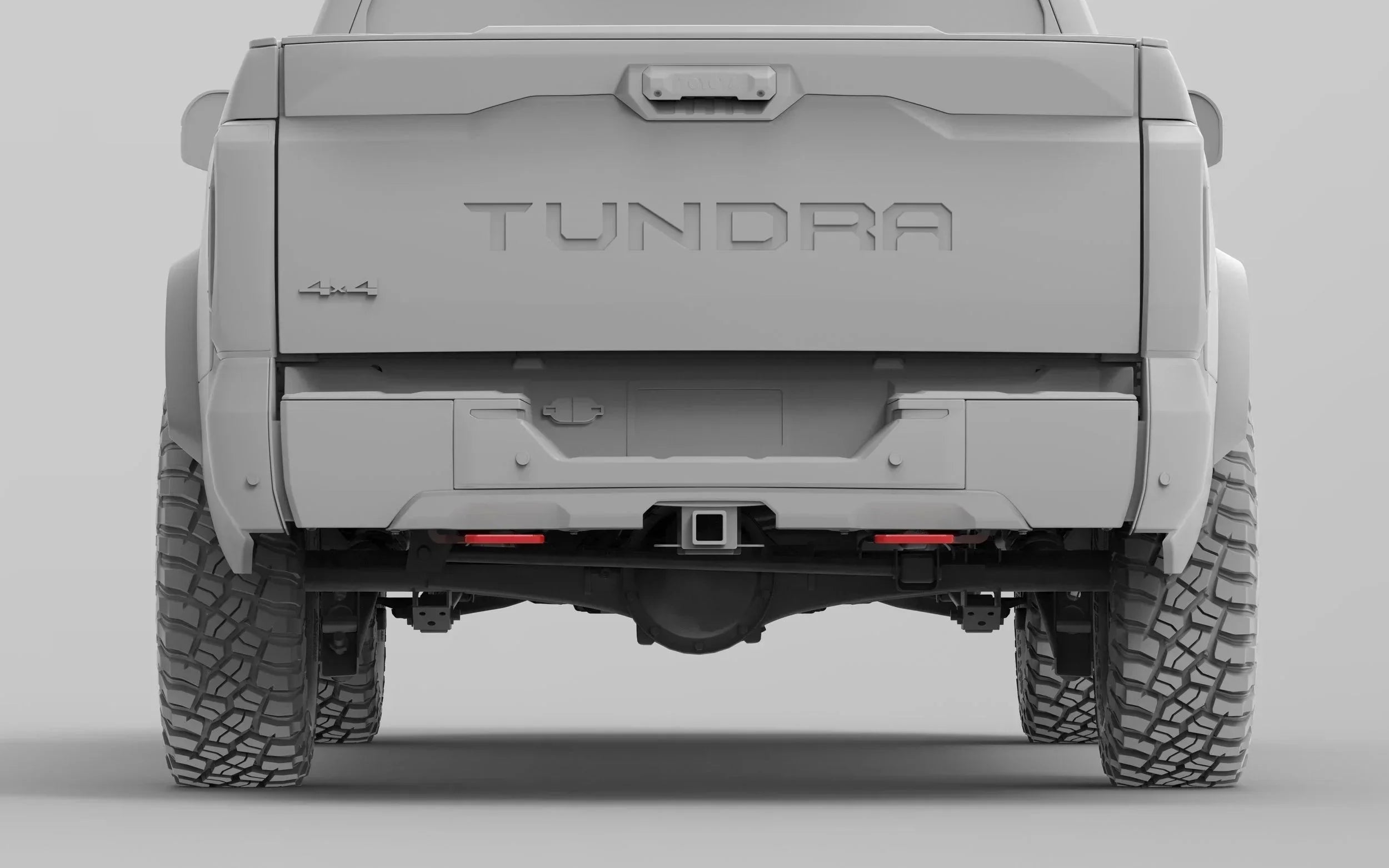 Rear view of Toyota Tundra 4x4 pickup truck with off-road tires and hitch receiver