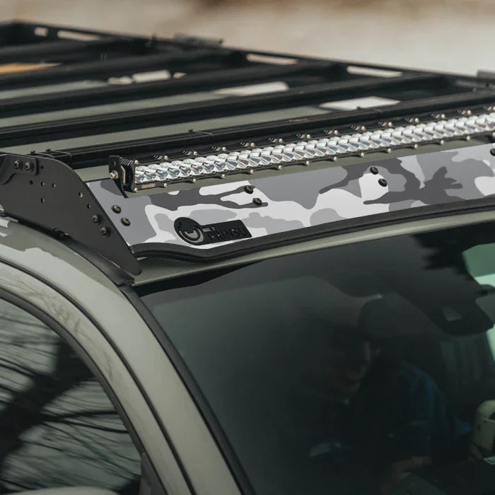 White camo vinyl wrap on vehicle roof rack with LED light bar, overland camping accessory