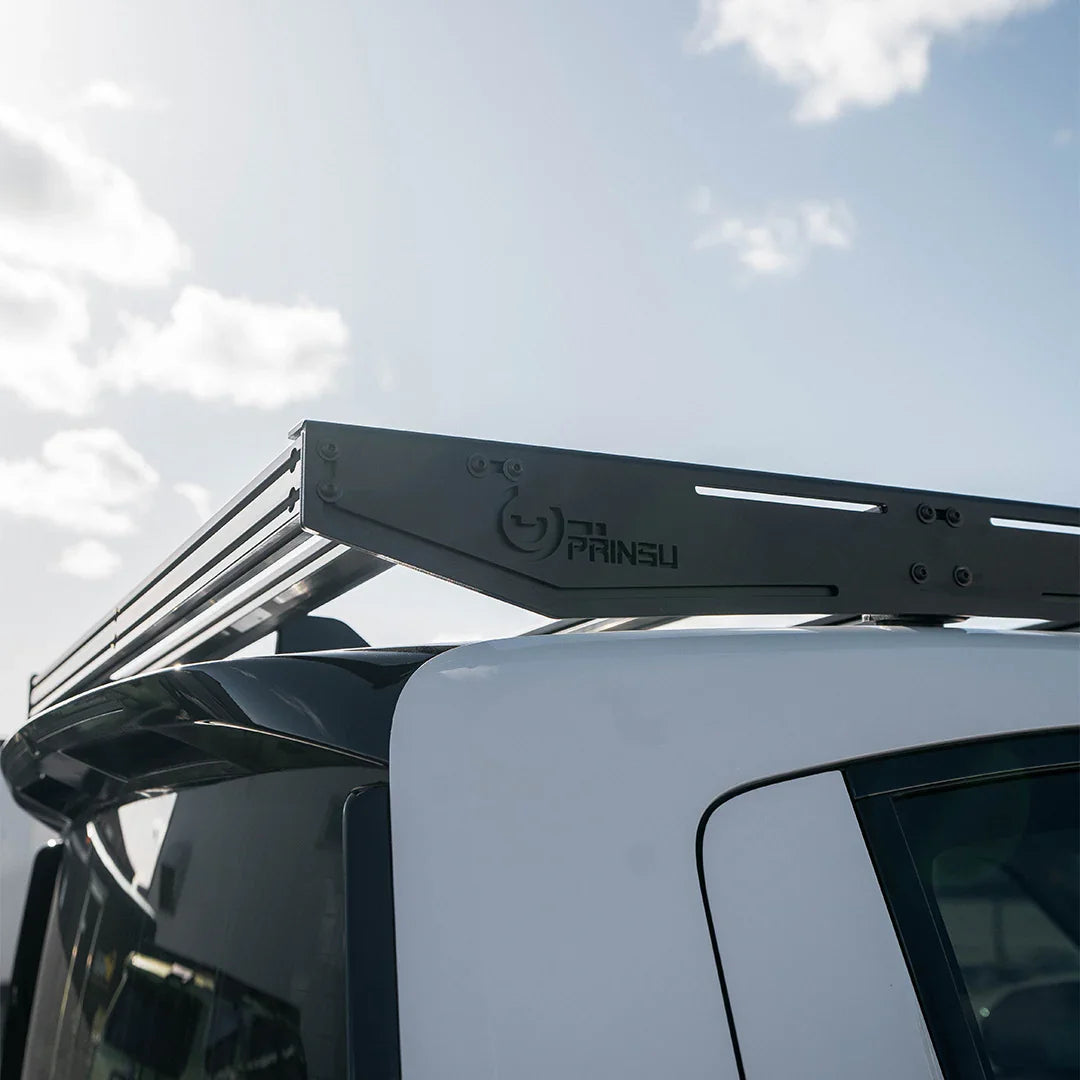 Rooftop Prinsu roof rack mounted on white Rivian SUV for overlanding and adventure gear
