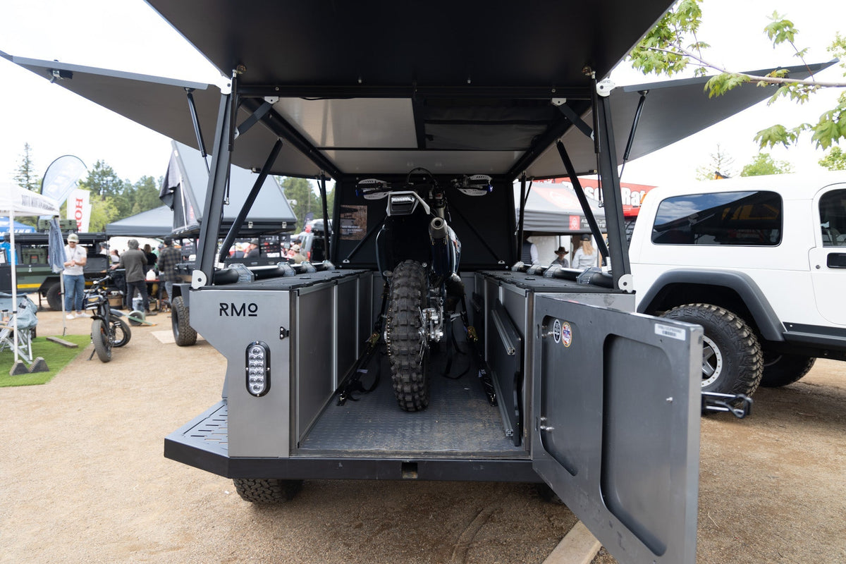 Rustic Mountain Overland Anzac moto hauler with Goose Gear utility modules on both sides and a motorcycle inside