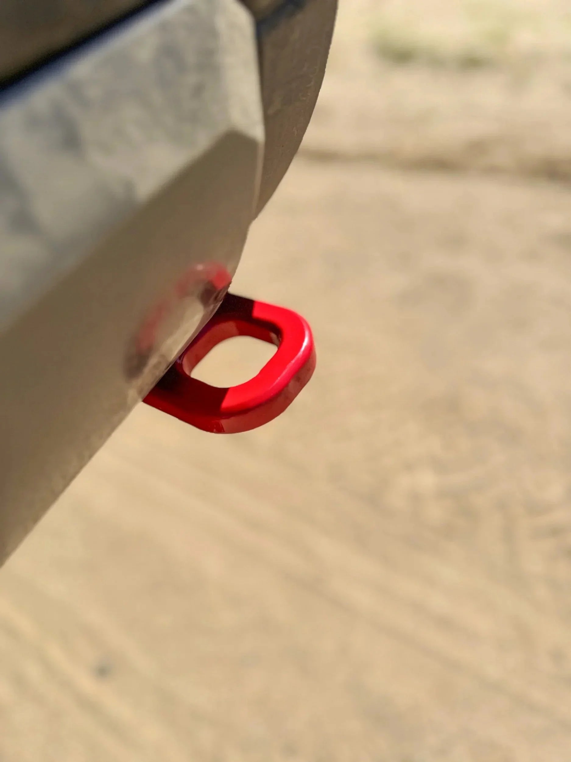 Red recovery point on off-road vehicle bumper, overlanding gear outdoors
