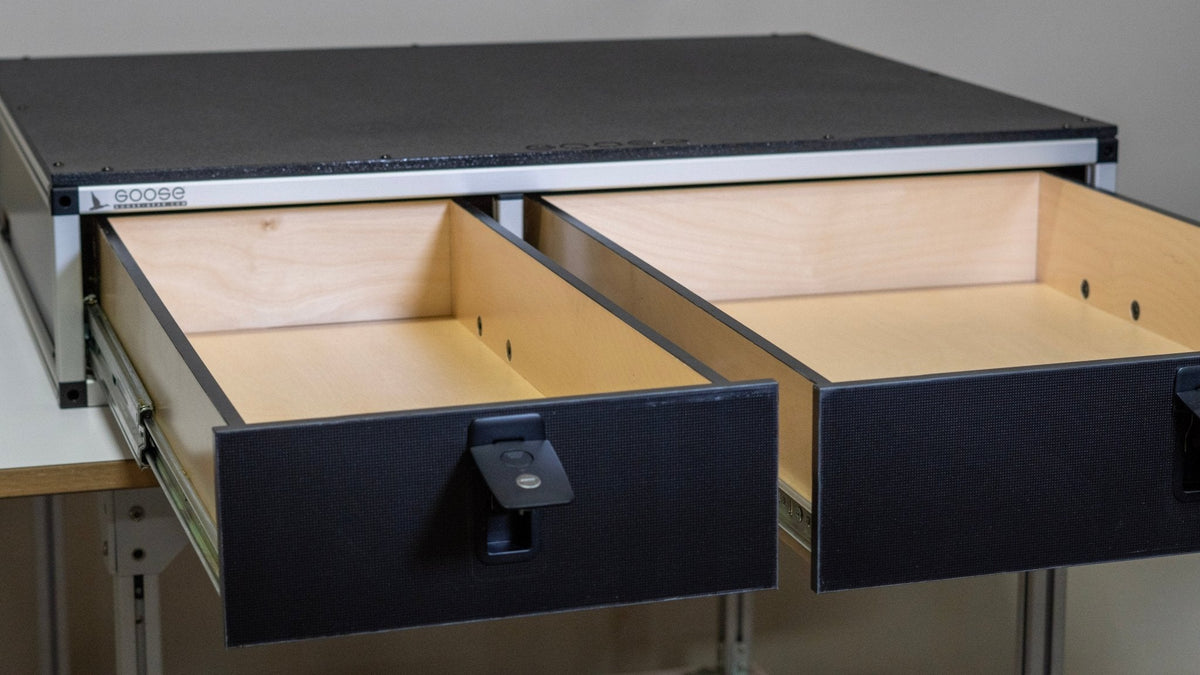 Goose Gear side-by-side drawer module with both birch plywood drawers pulled open, black fronts with latch handles