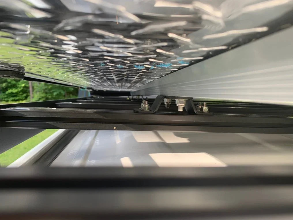 Close-up of overland roof rack mounting hardware on expedition vehicle.